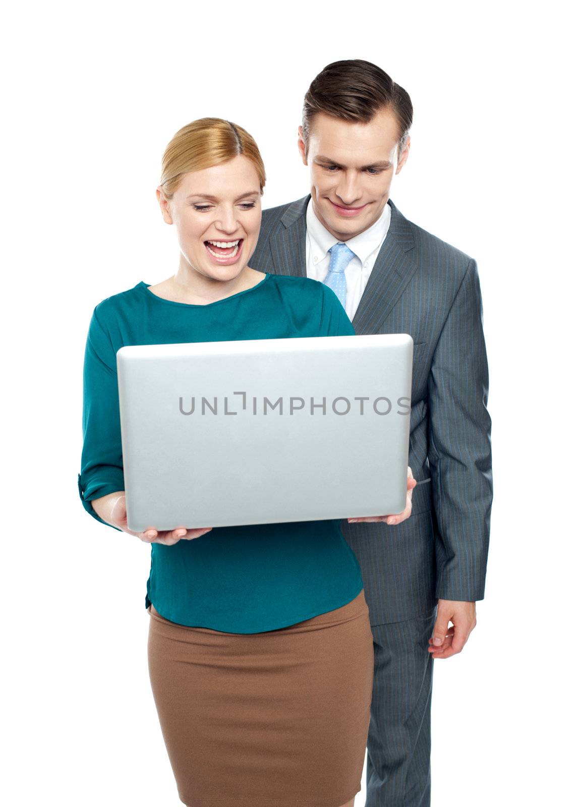 Business people enjoying funny videos on laptop over white background