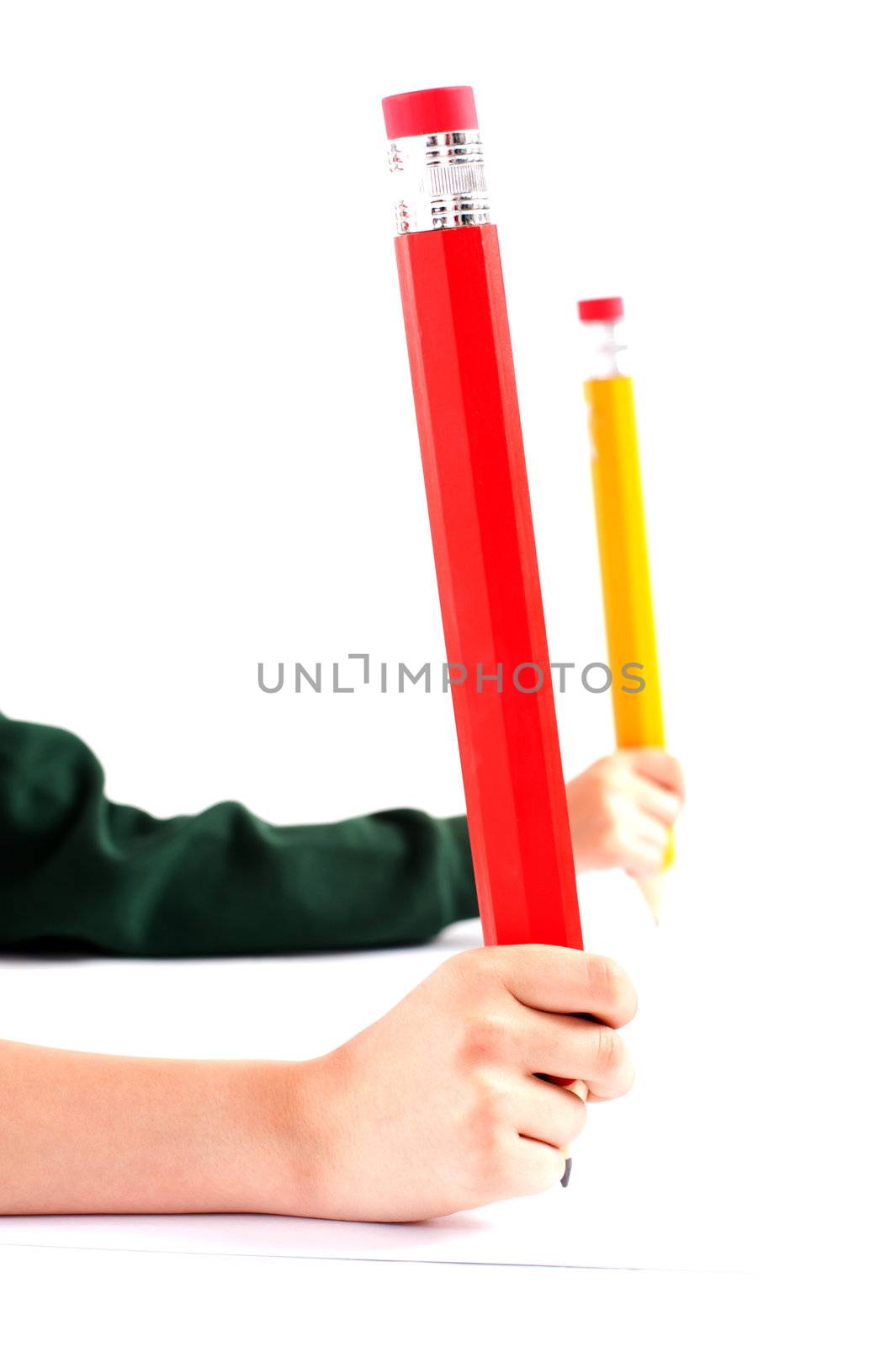 Two girls hands holding big pencil. Closeup shot