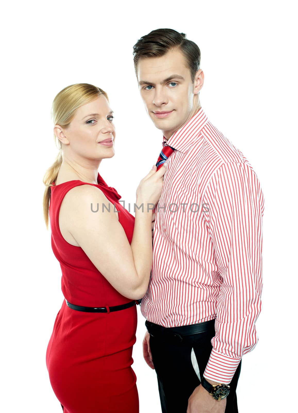 Woman grabbing man from his tie. Sensual shot