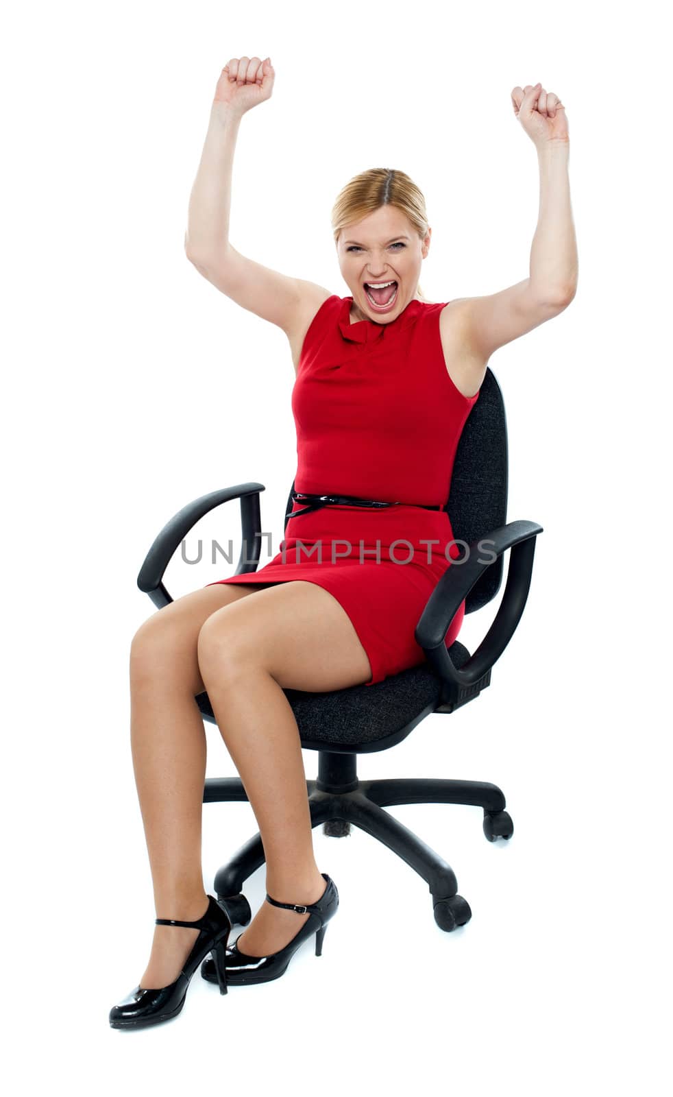 Excited woman sitting in chair. Isolated over white background