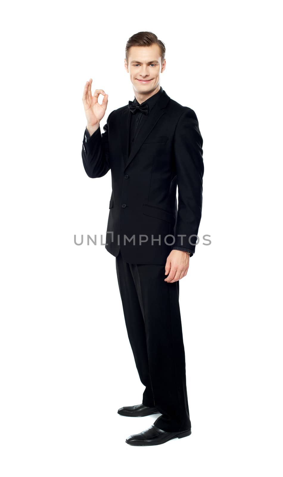 Handsome man showing excellent gesture, full length portrait