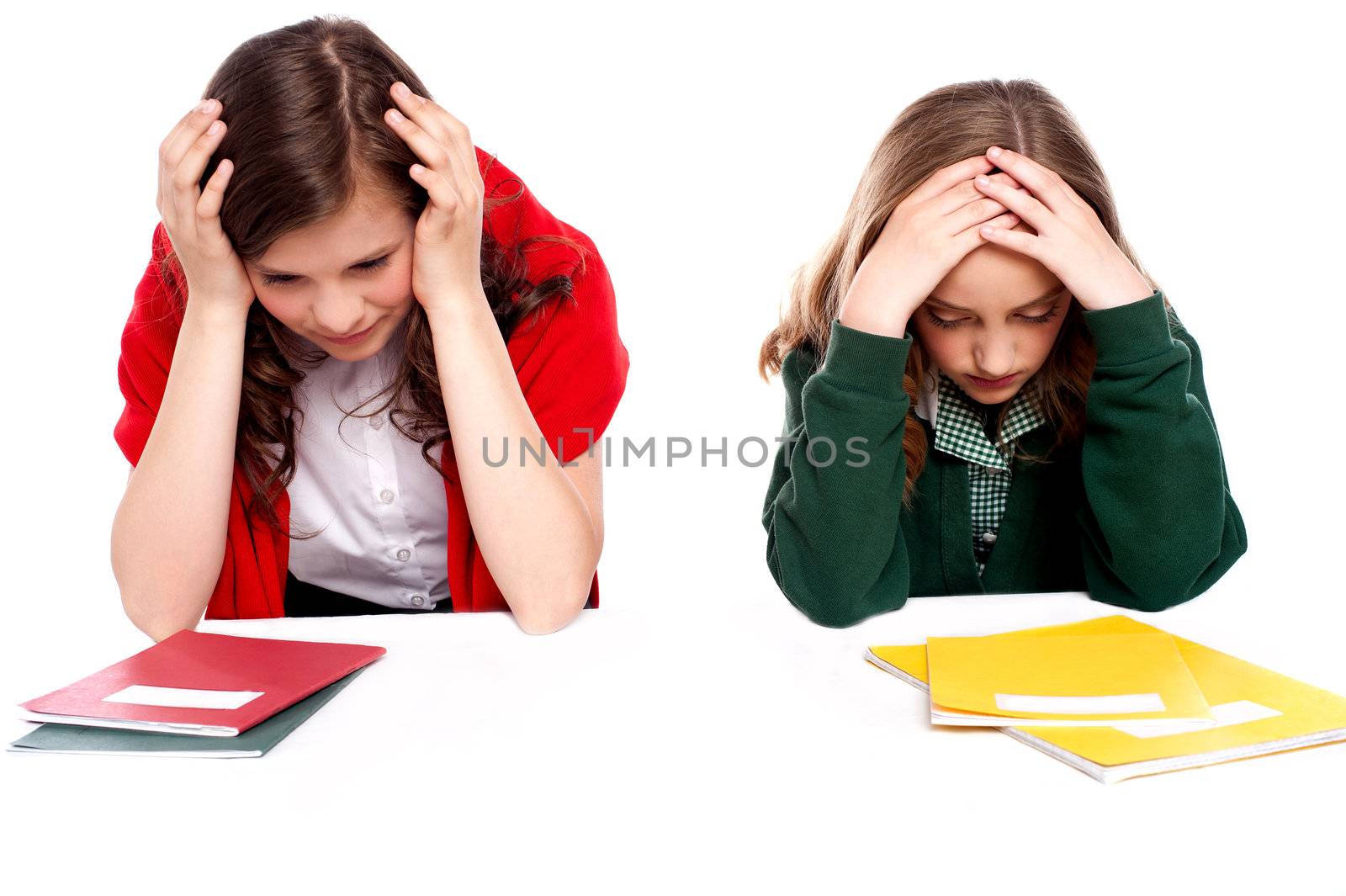 Confused students holding their heads and looking down