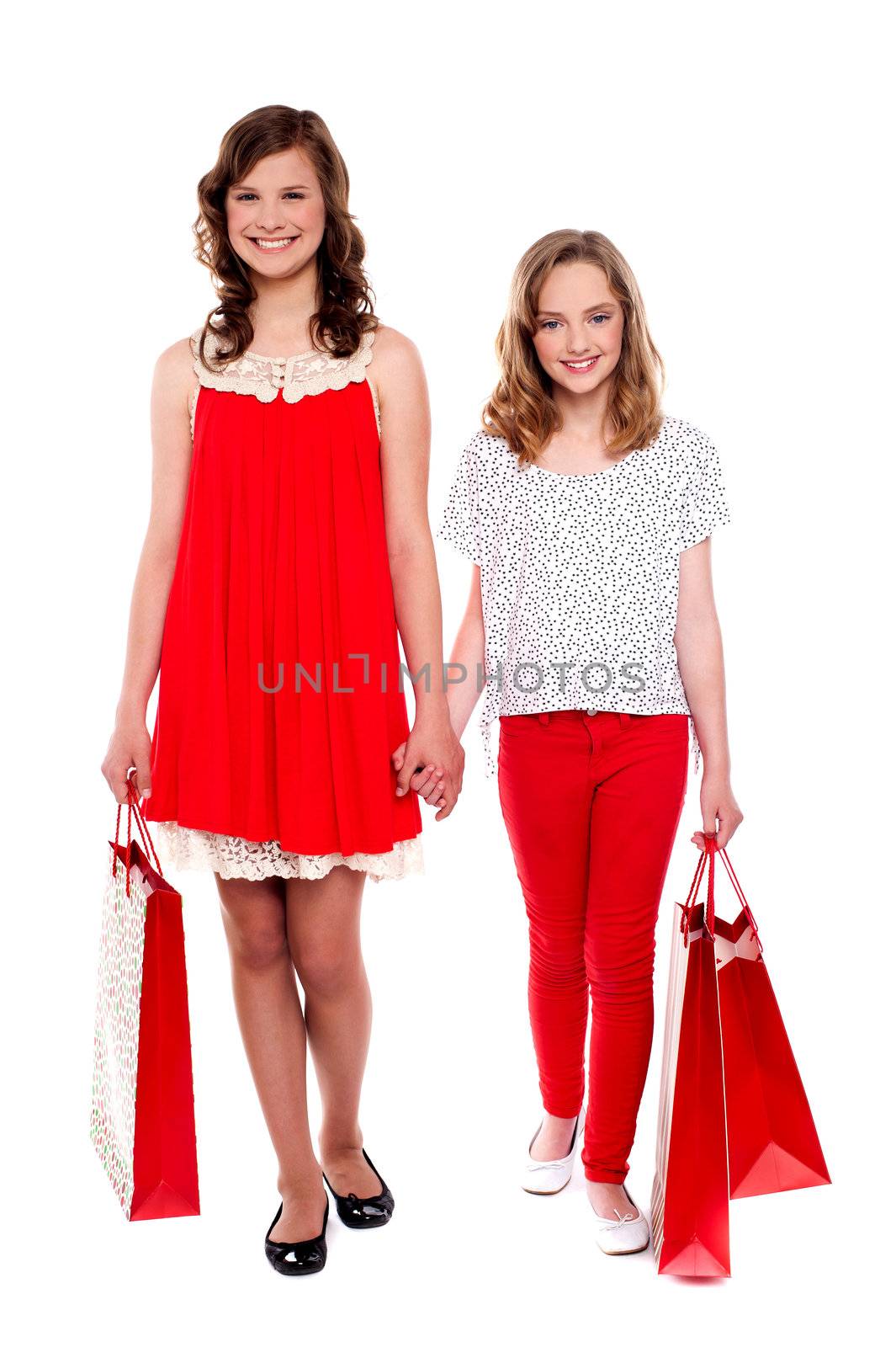 Glamorous girls walking after purchases against white background