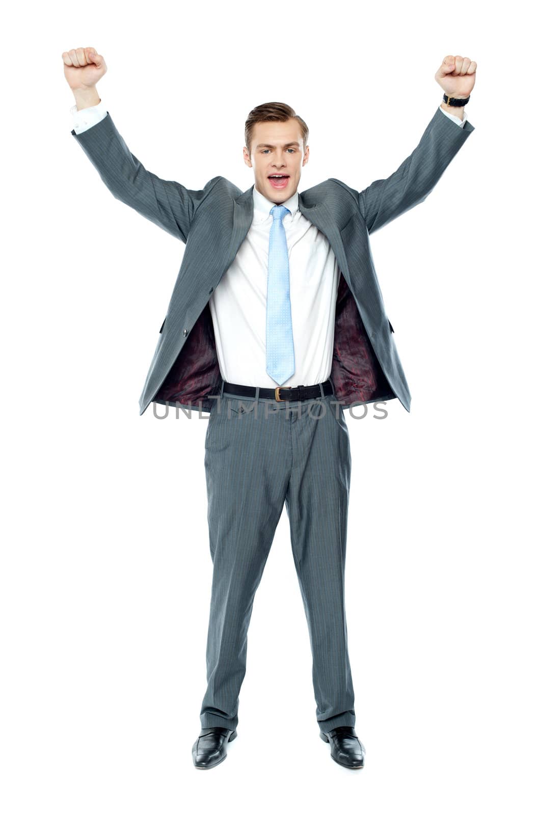 Full length portrait of a excited young executive posing with arms up