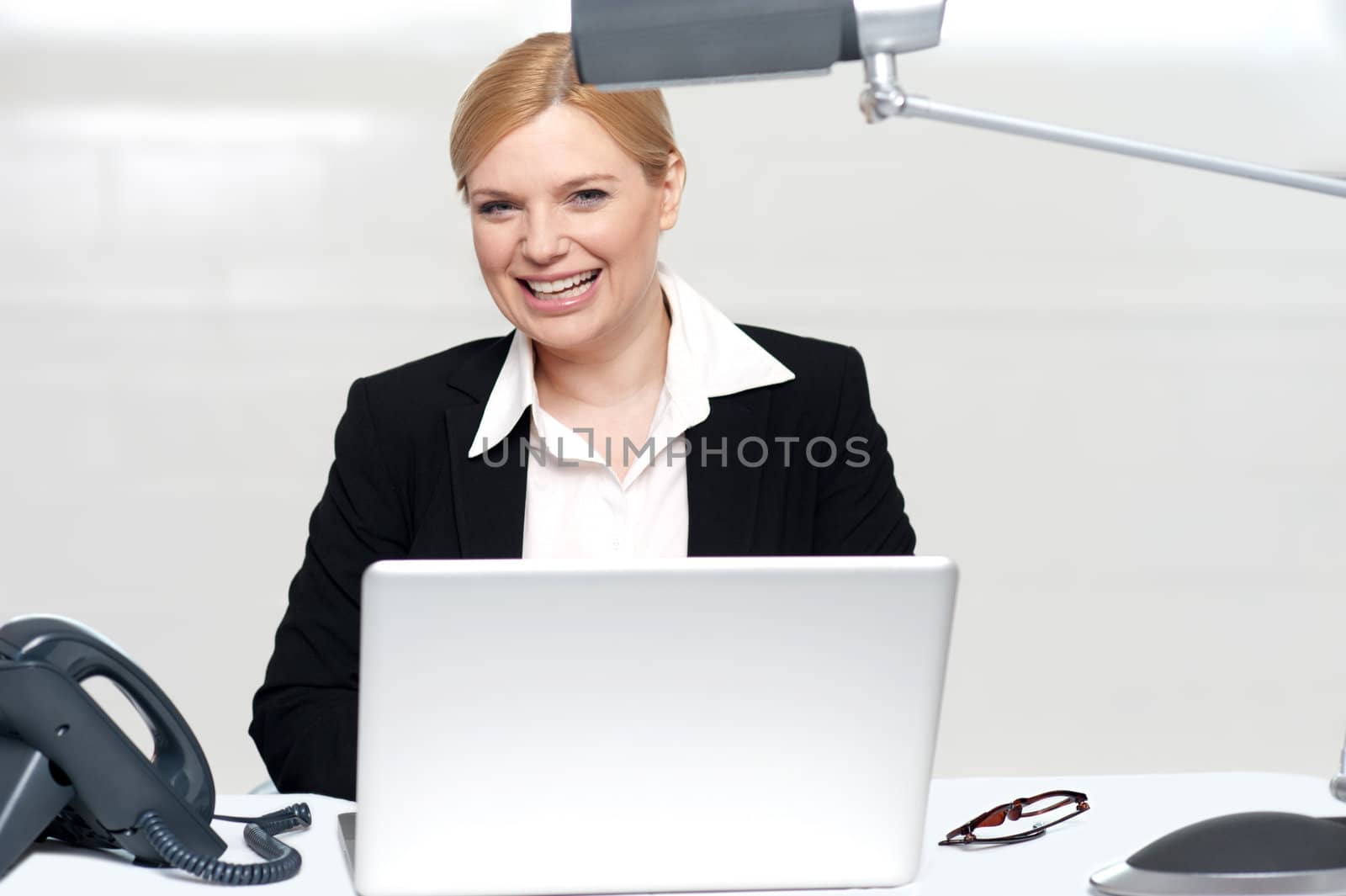 Pretty businesswoman at work. Operating laptop in office