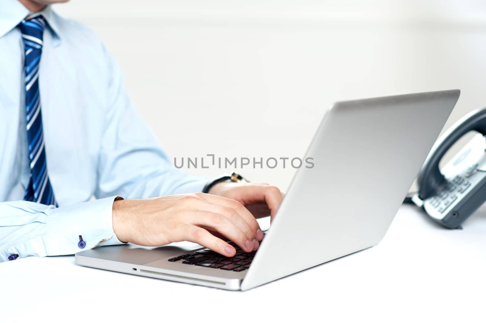 Closeup shot of man working on a laptop isolated over white background