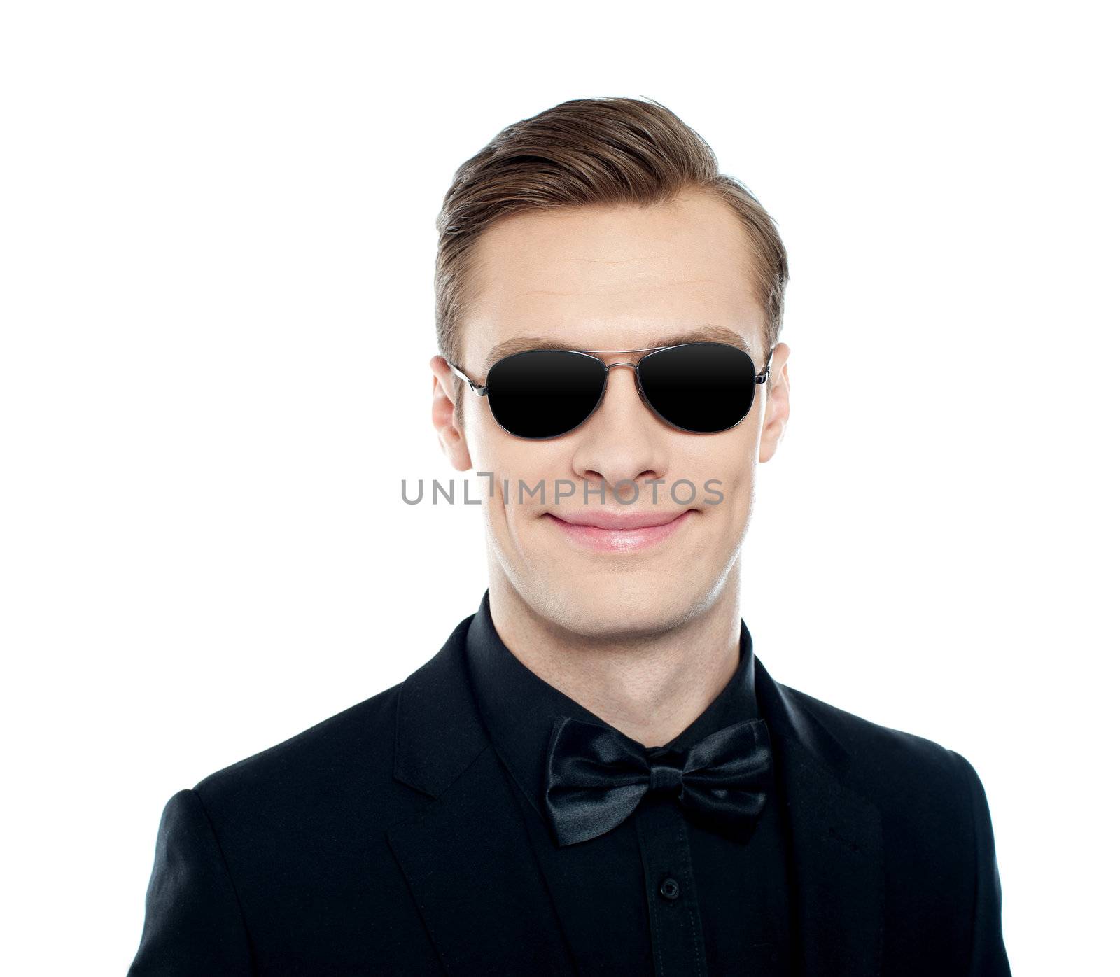 Trendy young male model wearing goggles and smiling