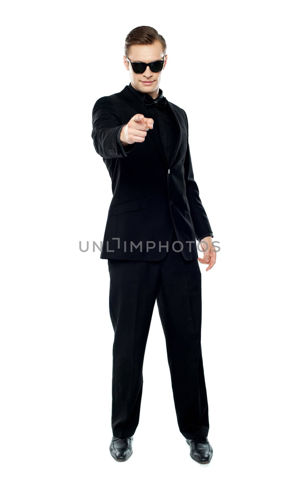 Man in party wear attire pointing at camera wearing black goggles