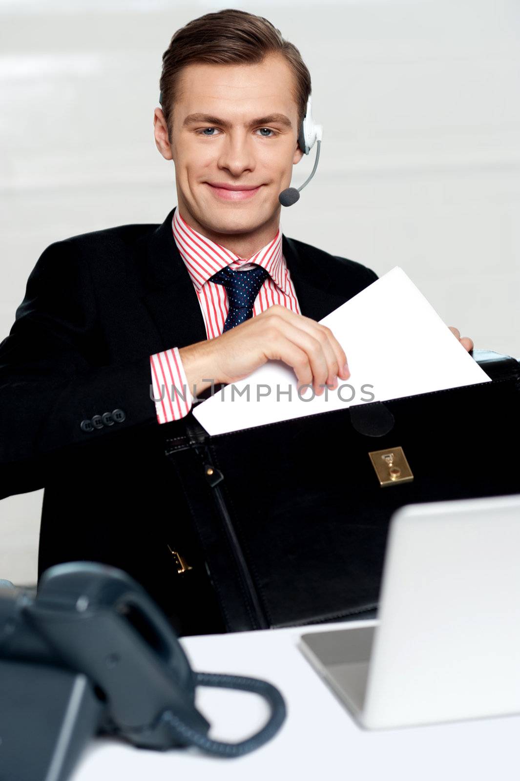 Customer care person arranging office documents. Sitting in office