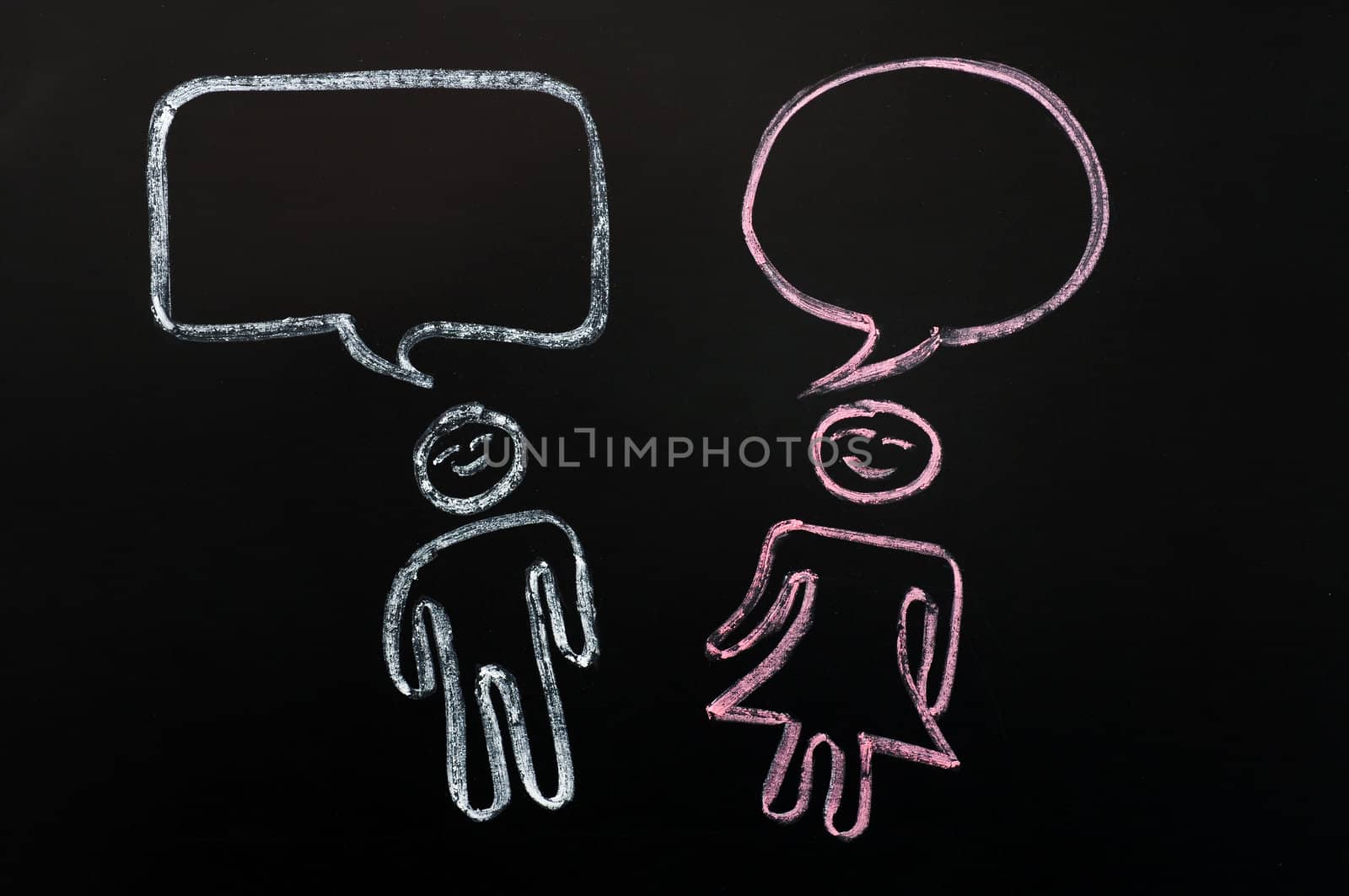 Chalk drawing of blank speech bubbles with human figures on a blackboard background