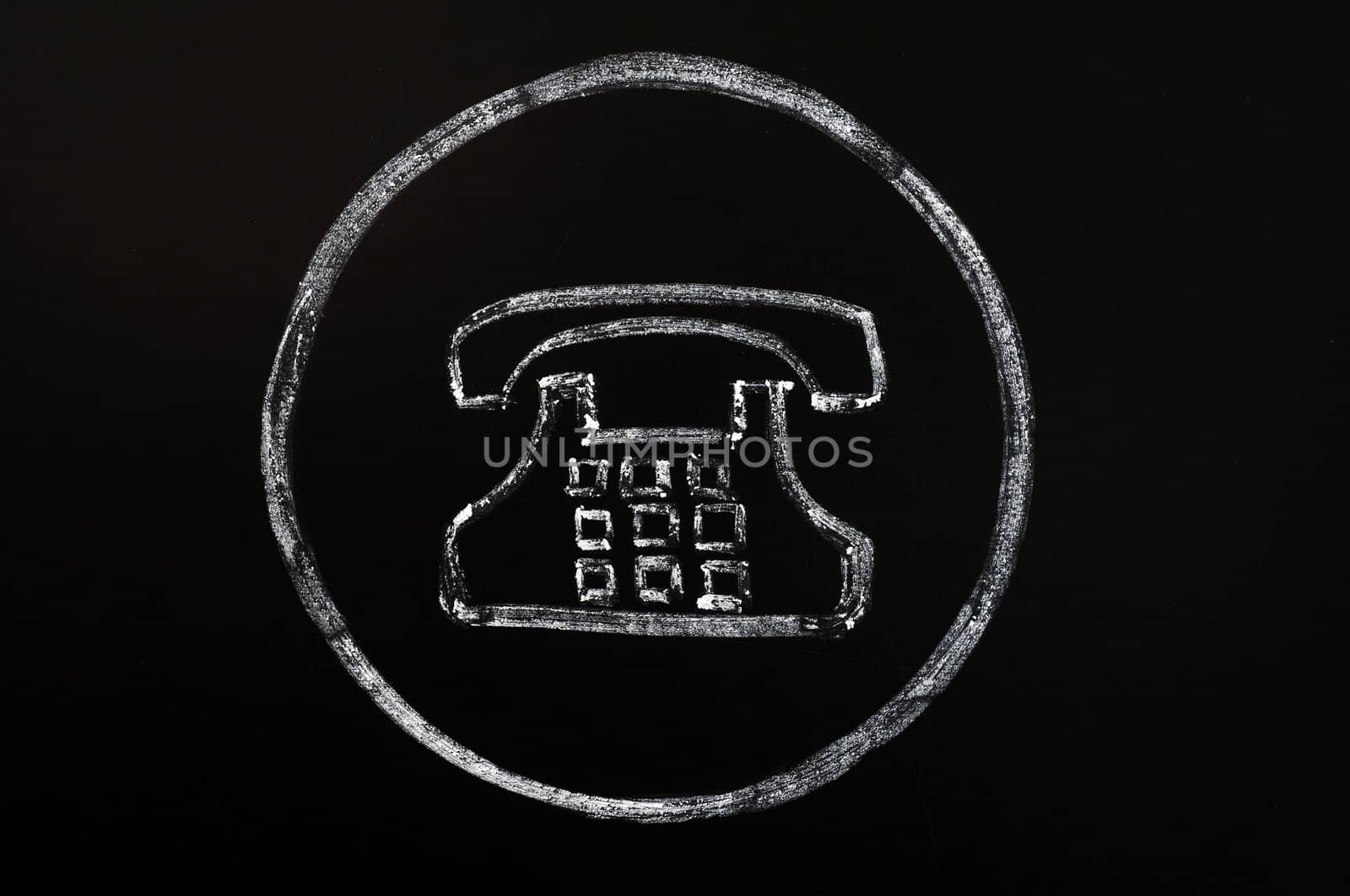 Old phone symbol drawn with chalk on a blackboard background