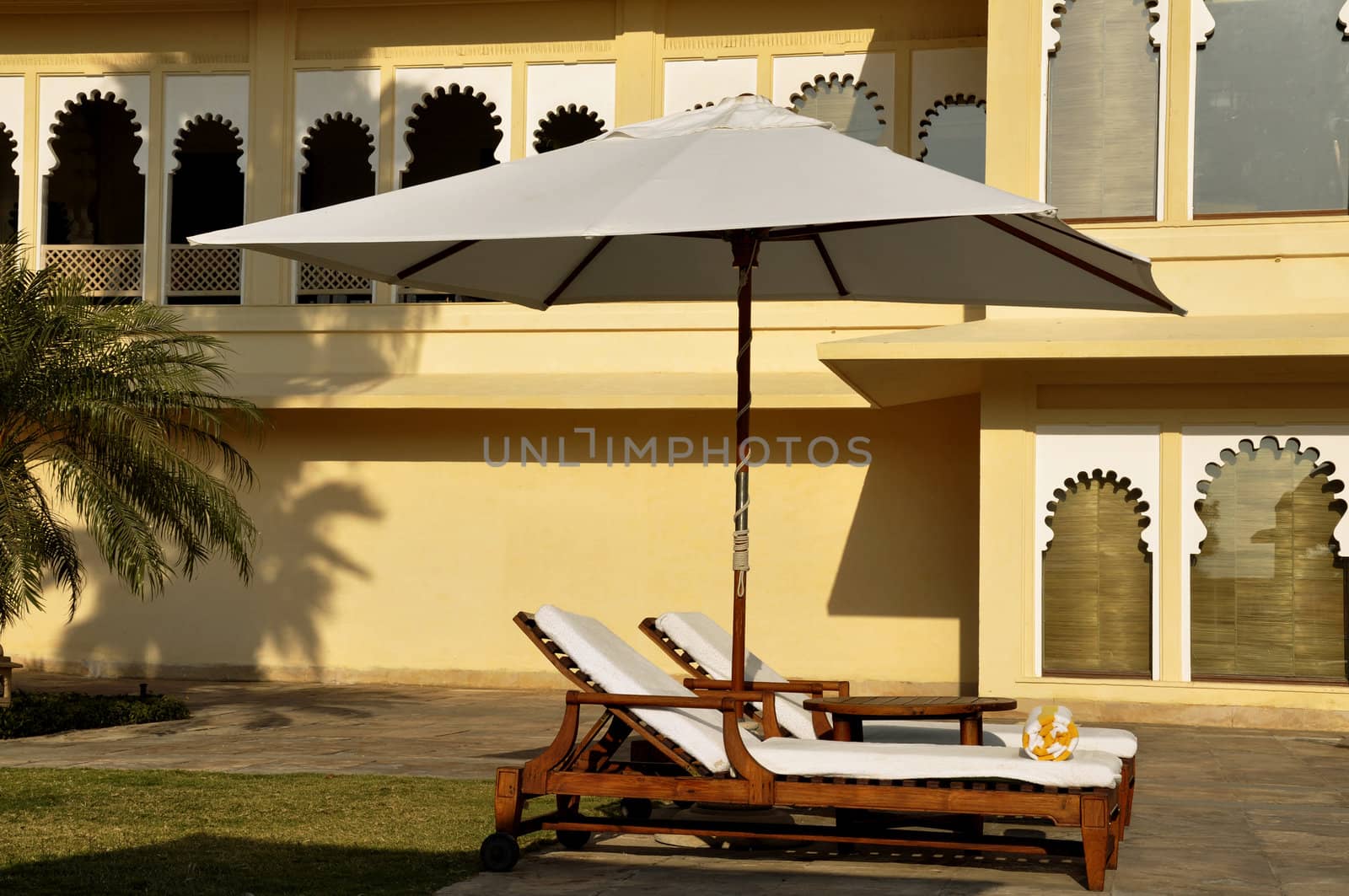 Sunbeds against medieval architecture in Udaipur, India by kdreams02