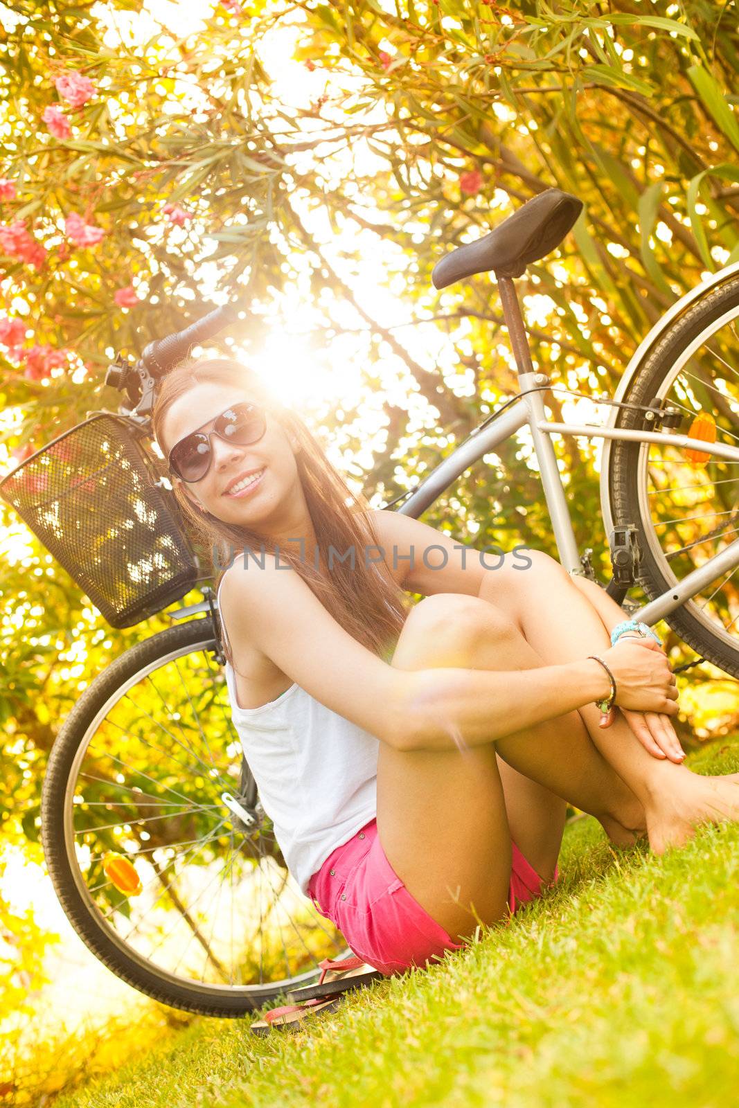 young beautiful woman laying on the grass in summer