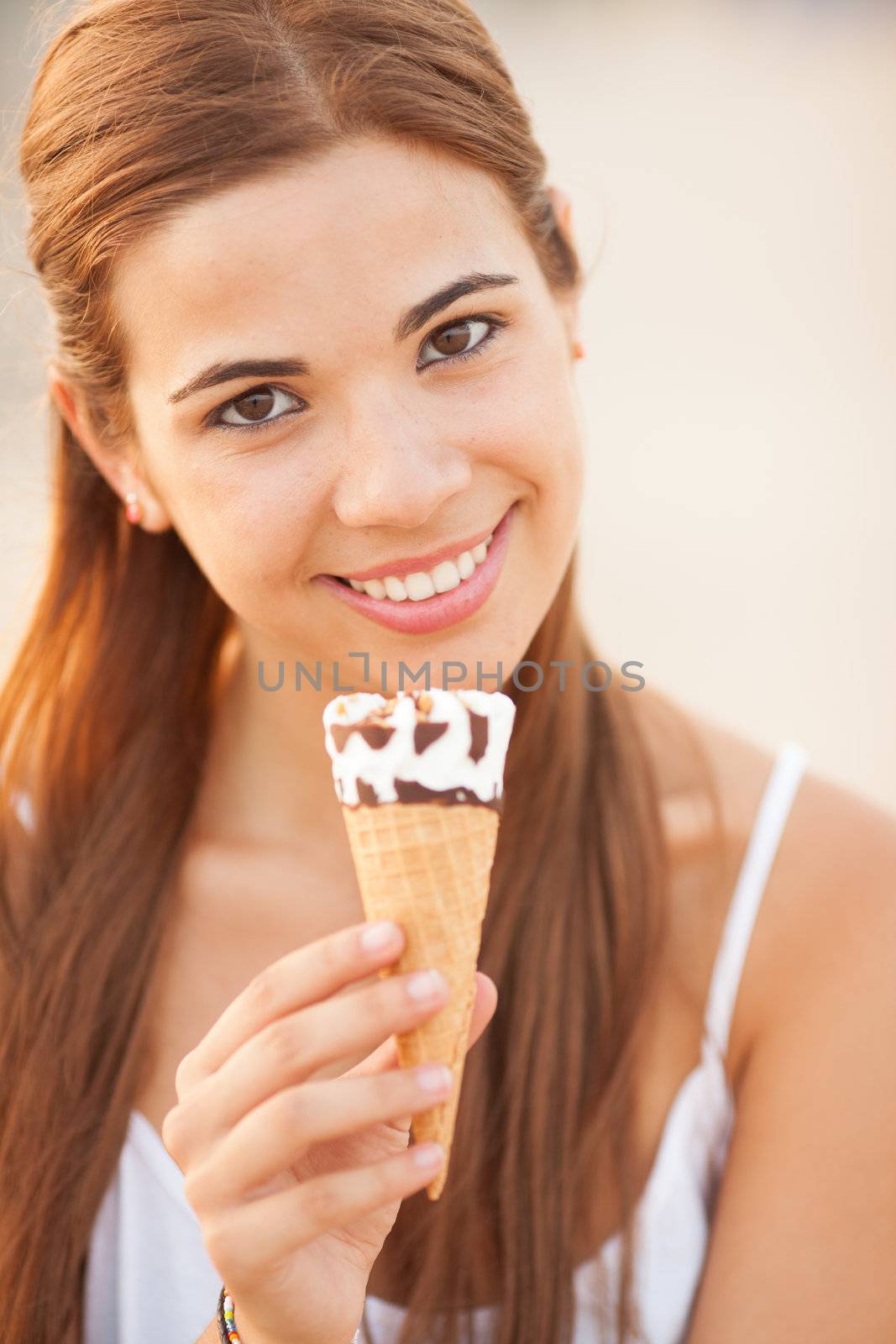 portrait of a young beautiful woman eating ice-cream cone by Lcrespi