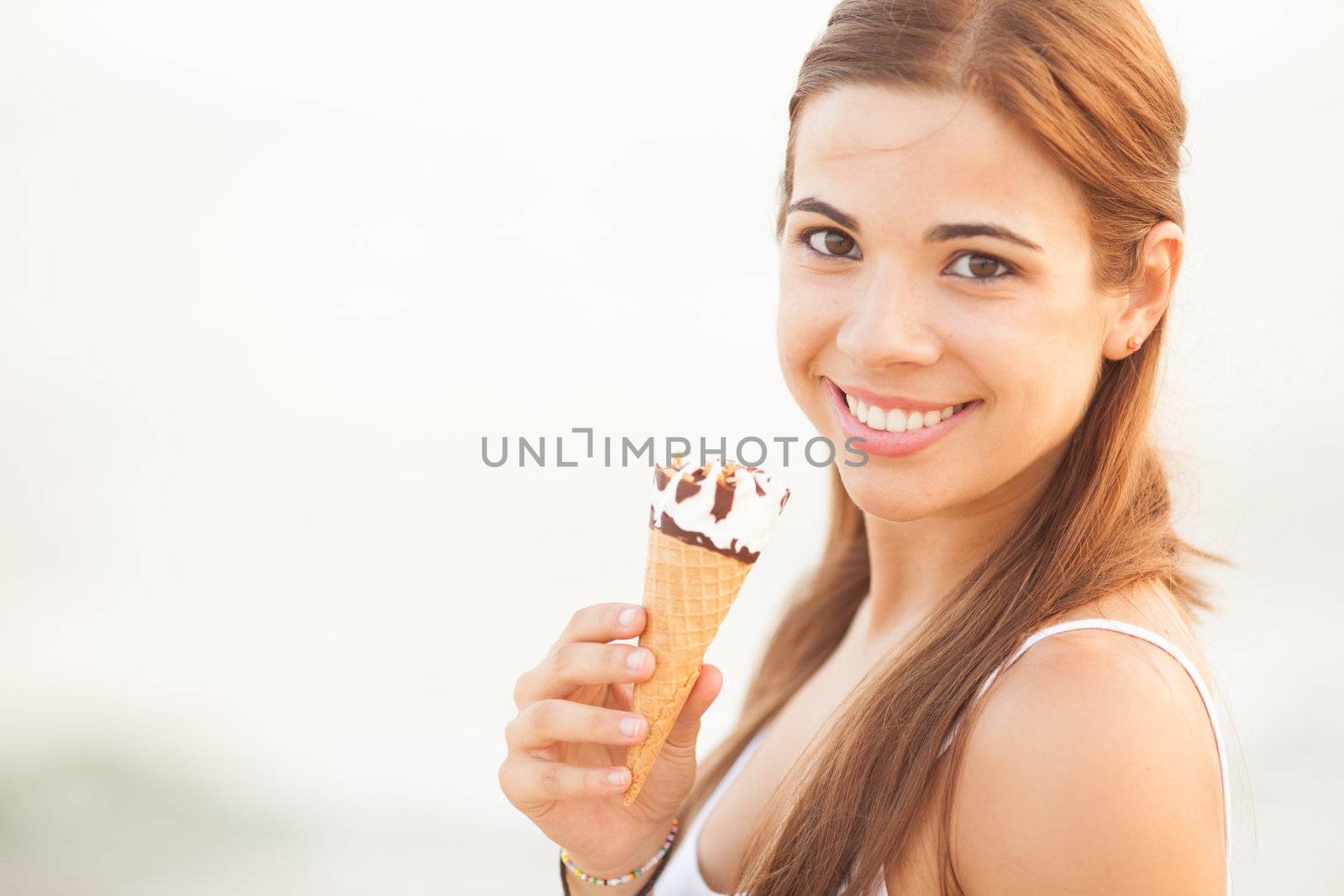 portrait of a young beautiful woman eating ice-cream cone by Lcrespi