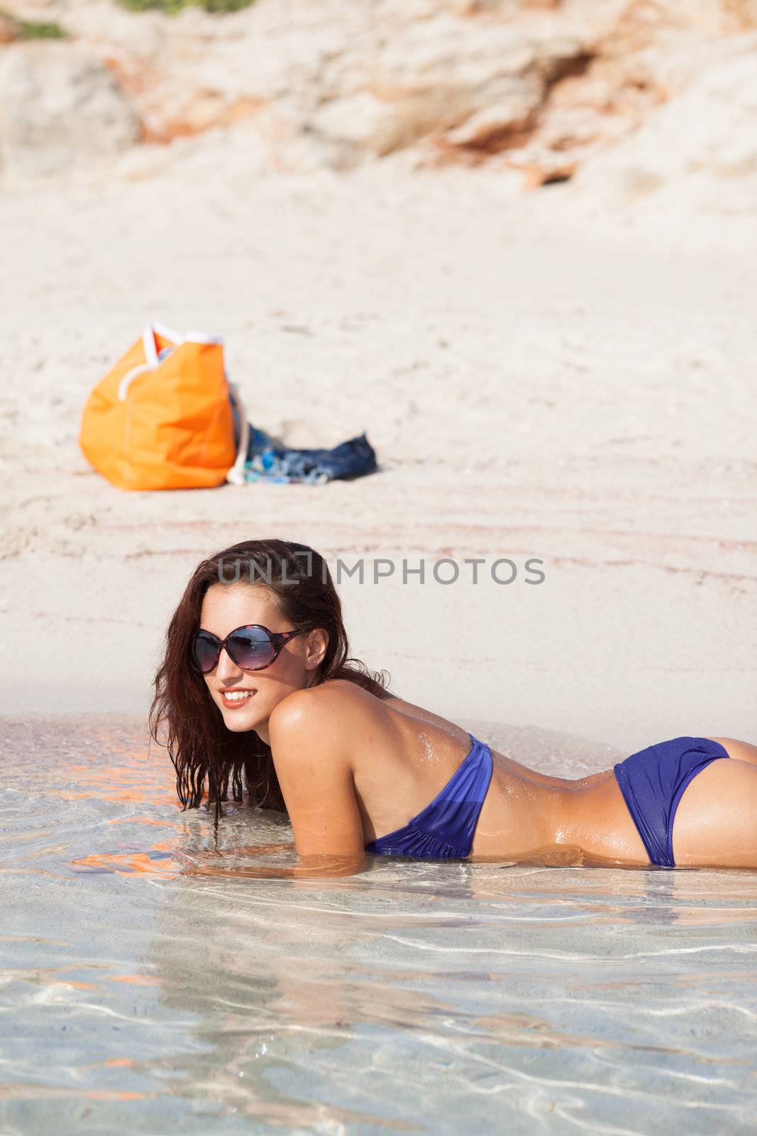 sexy beautiful model laying. having fun on shore by Lcrespi