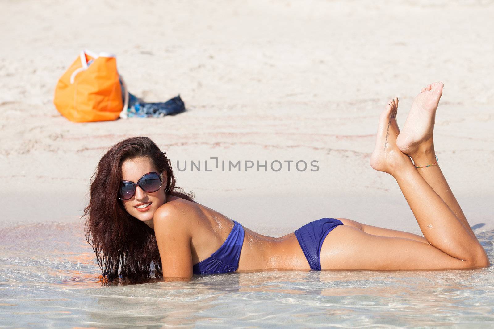 sexy beautiful model laying on vacation. having fun on shore