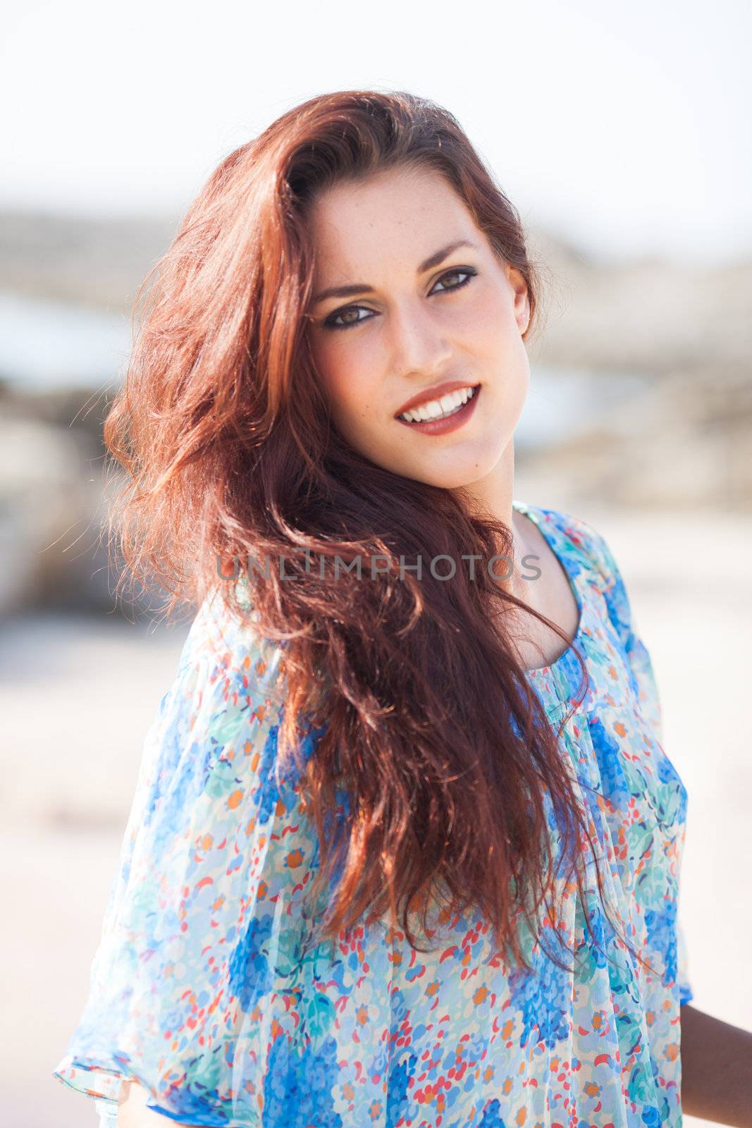 sexy beautiful woman portrait on the beach wearing a blue shirt