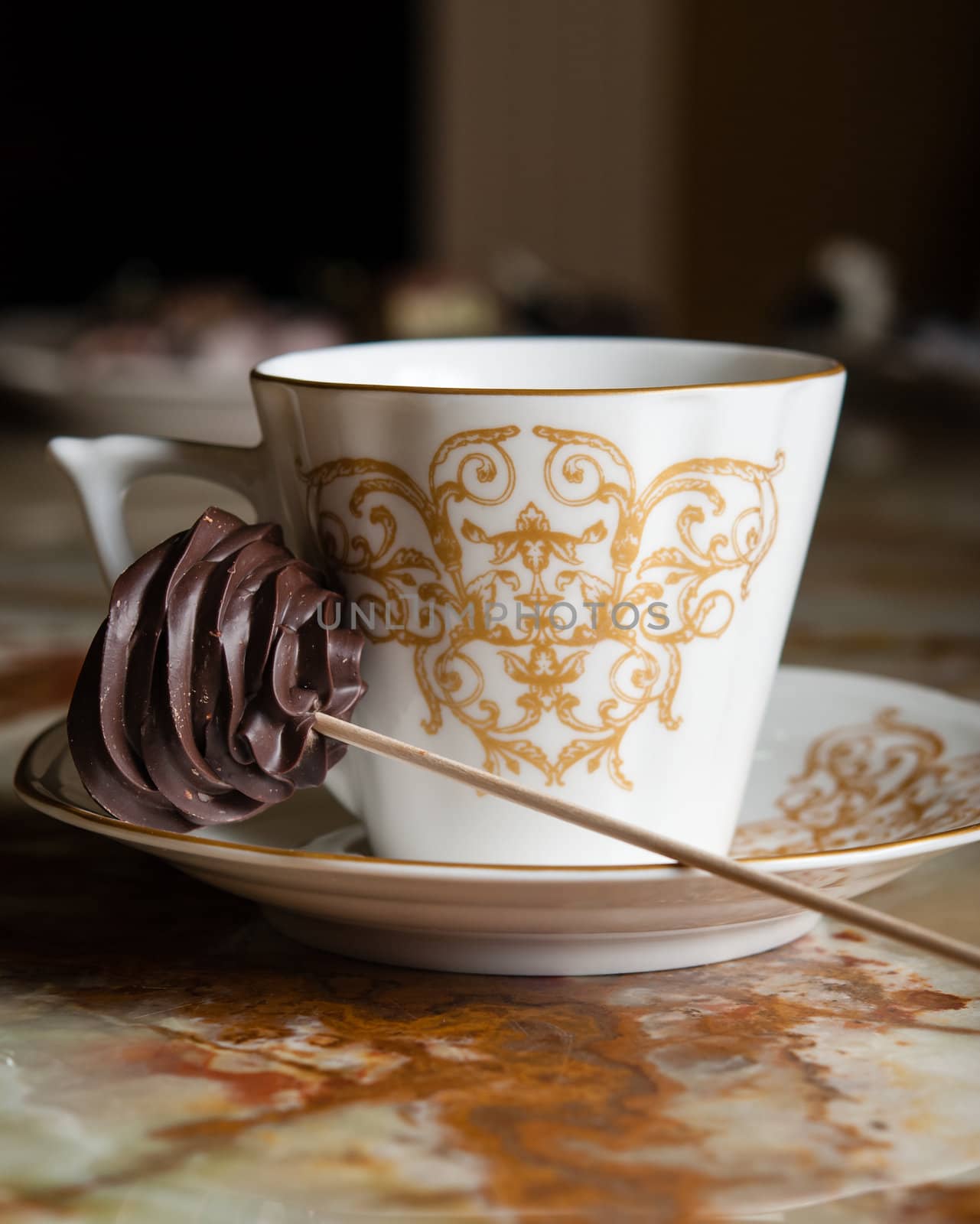 Cup of coffee and handmaded chocolate candie on stick