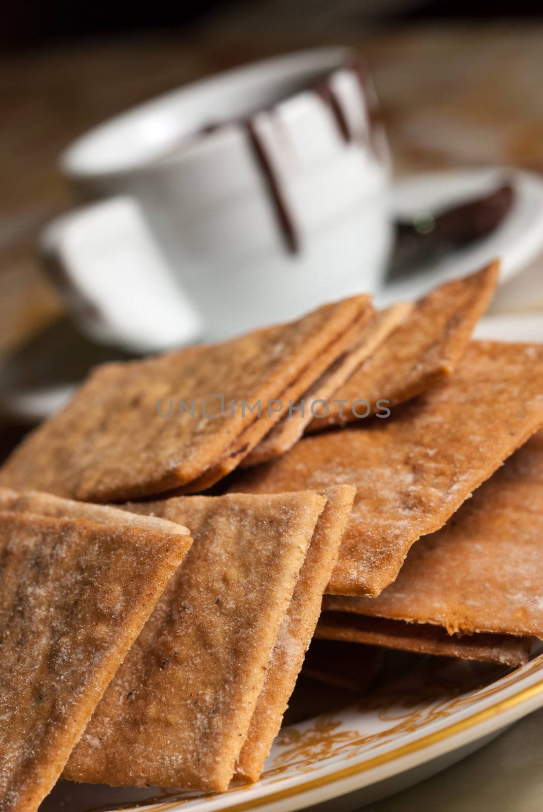 Plate full of cookies and coffe cup with chocolate flowing