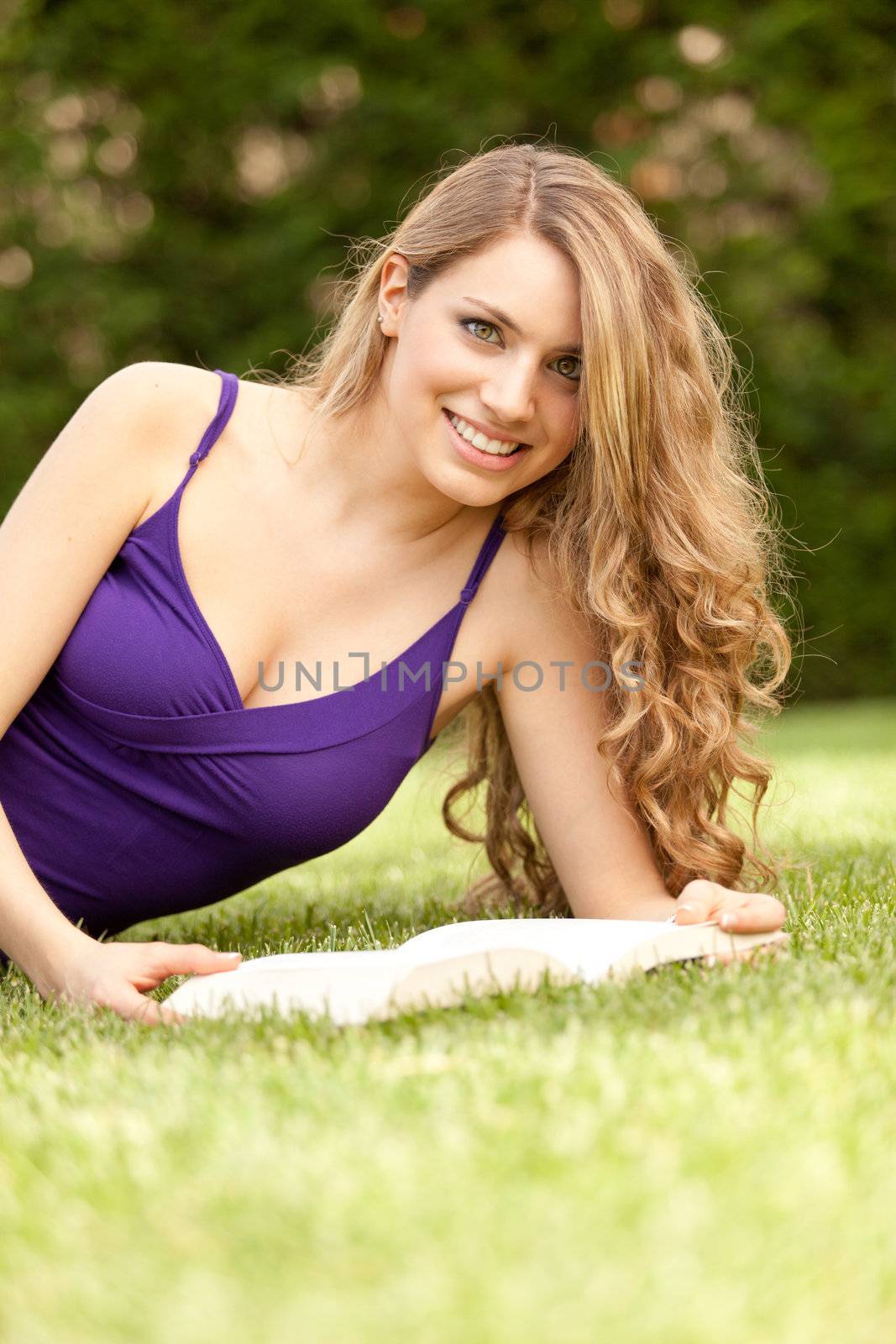 young beautiful woman reading a book at home