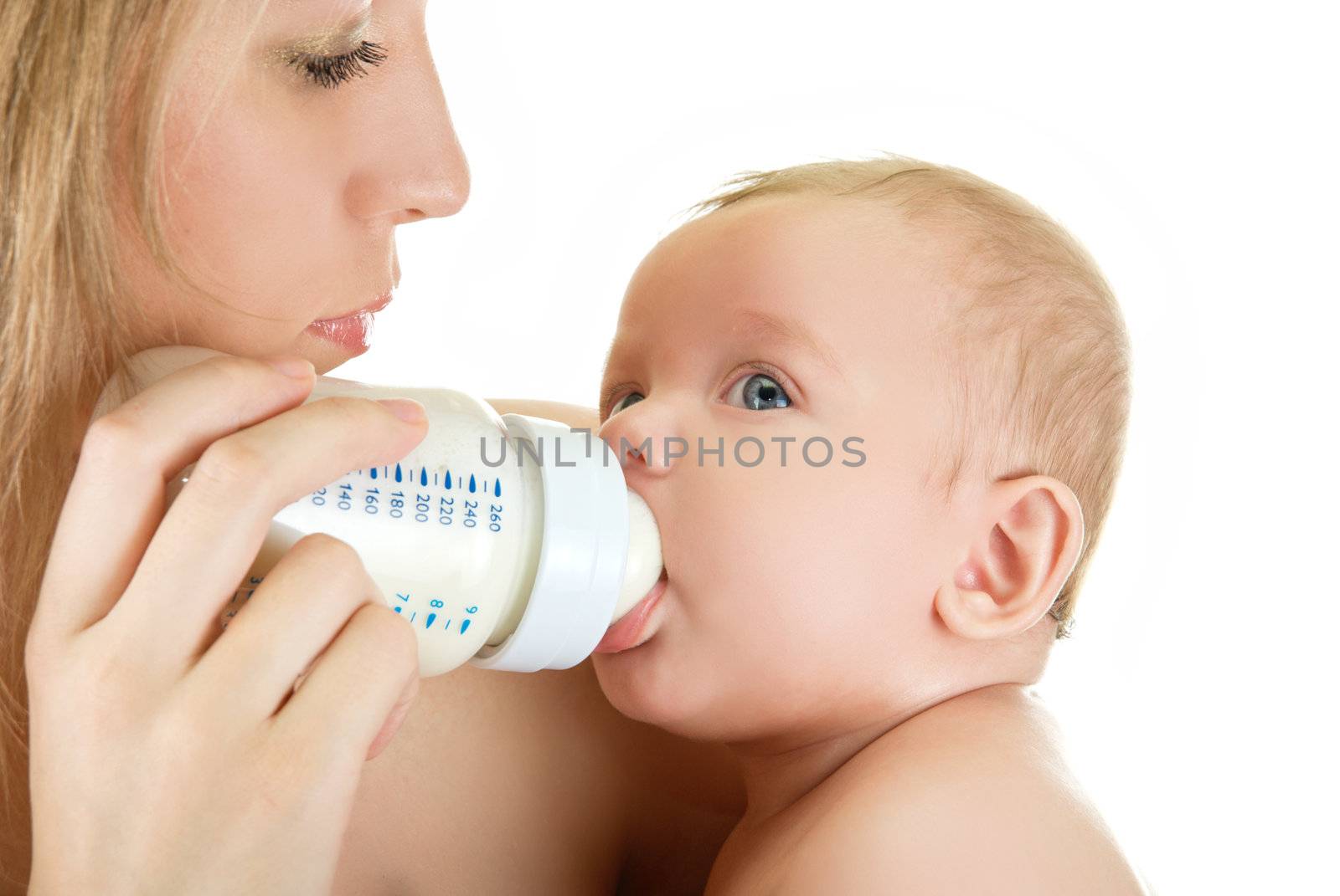 Mother give drink her baby boy by feeding bottle