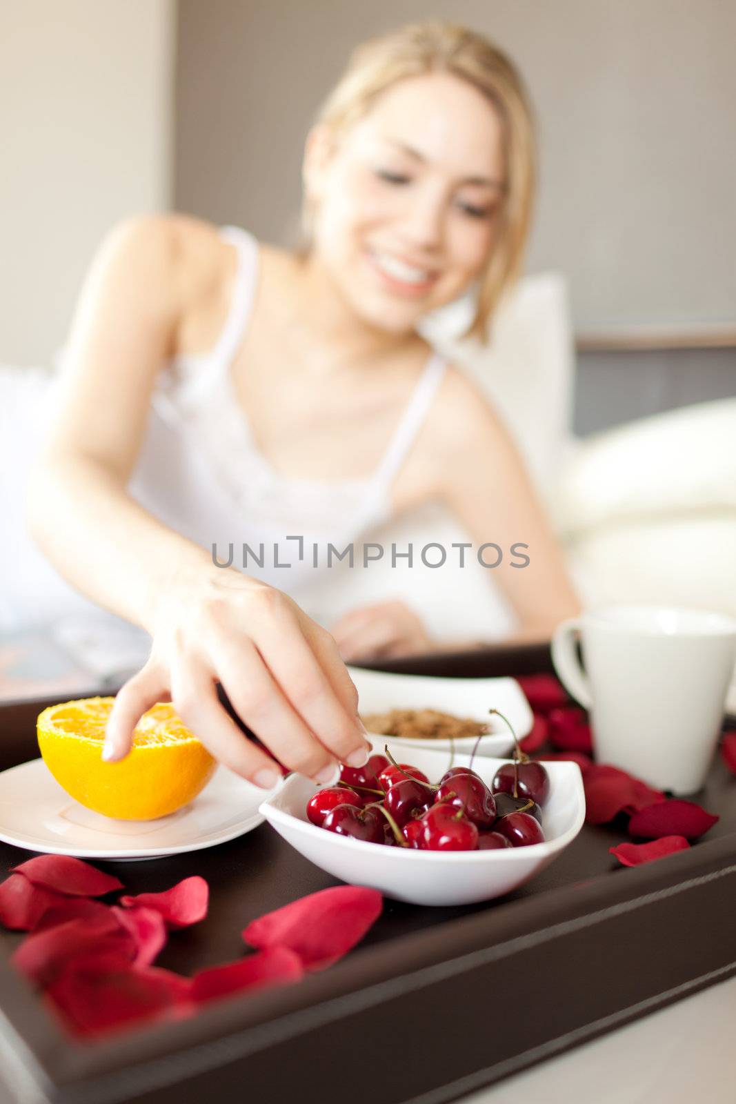 cherries detail in a women breakfast on bed