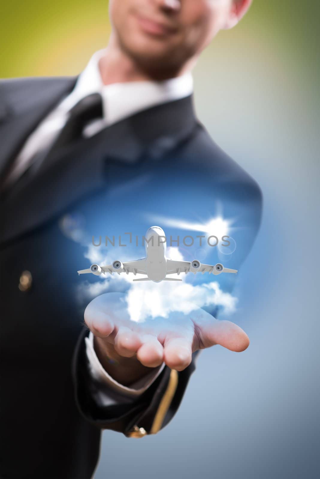 pilot in the form of extending a hand to a flying airplane with sky, clouds and sun