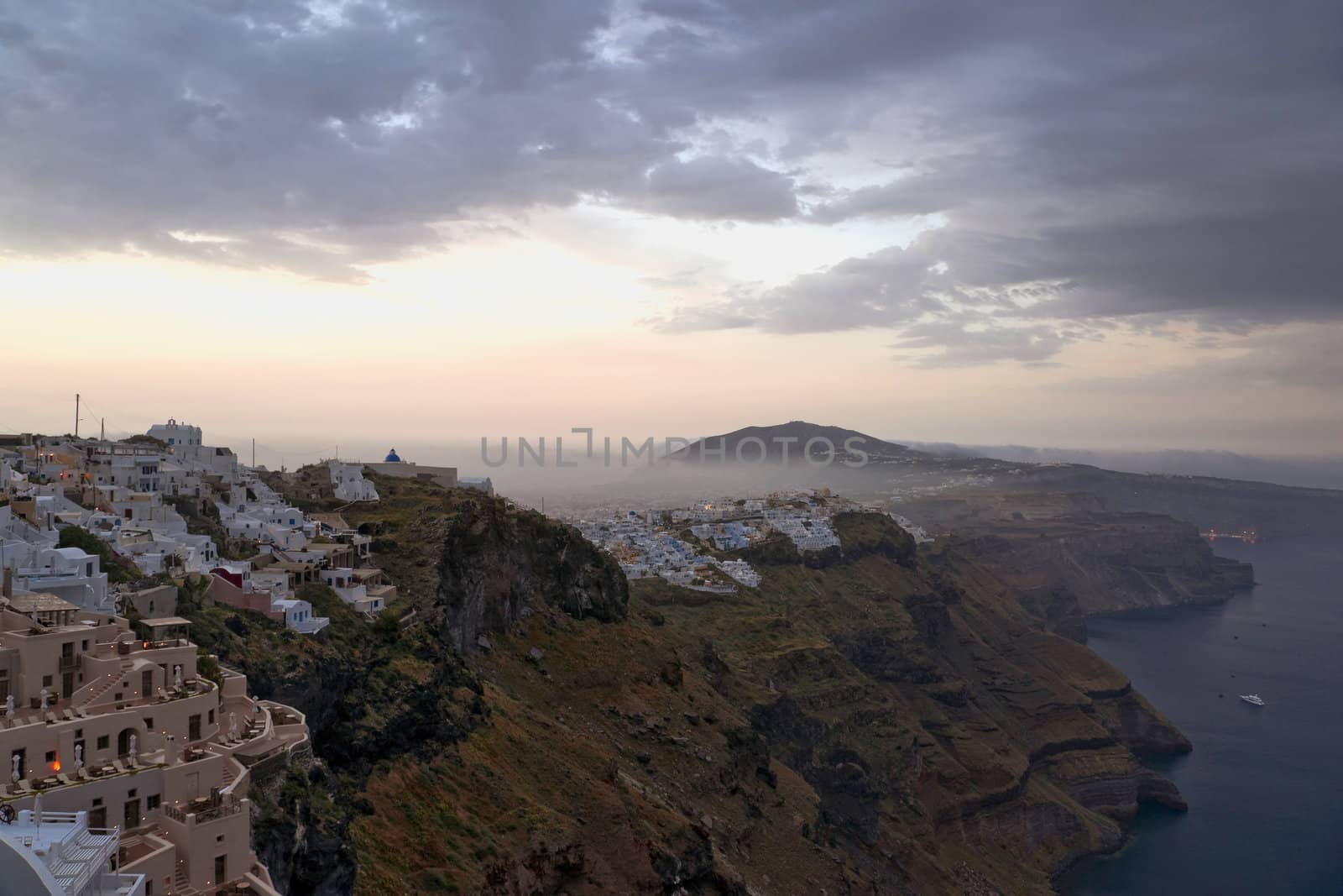 Early morning fog above Santorini villages and sunrise