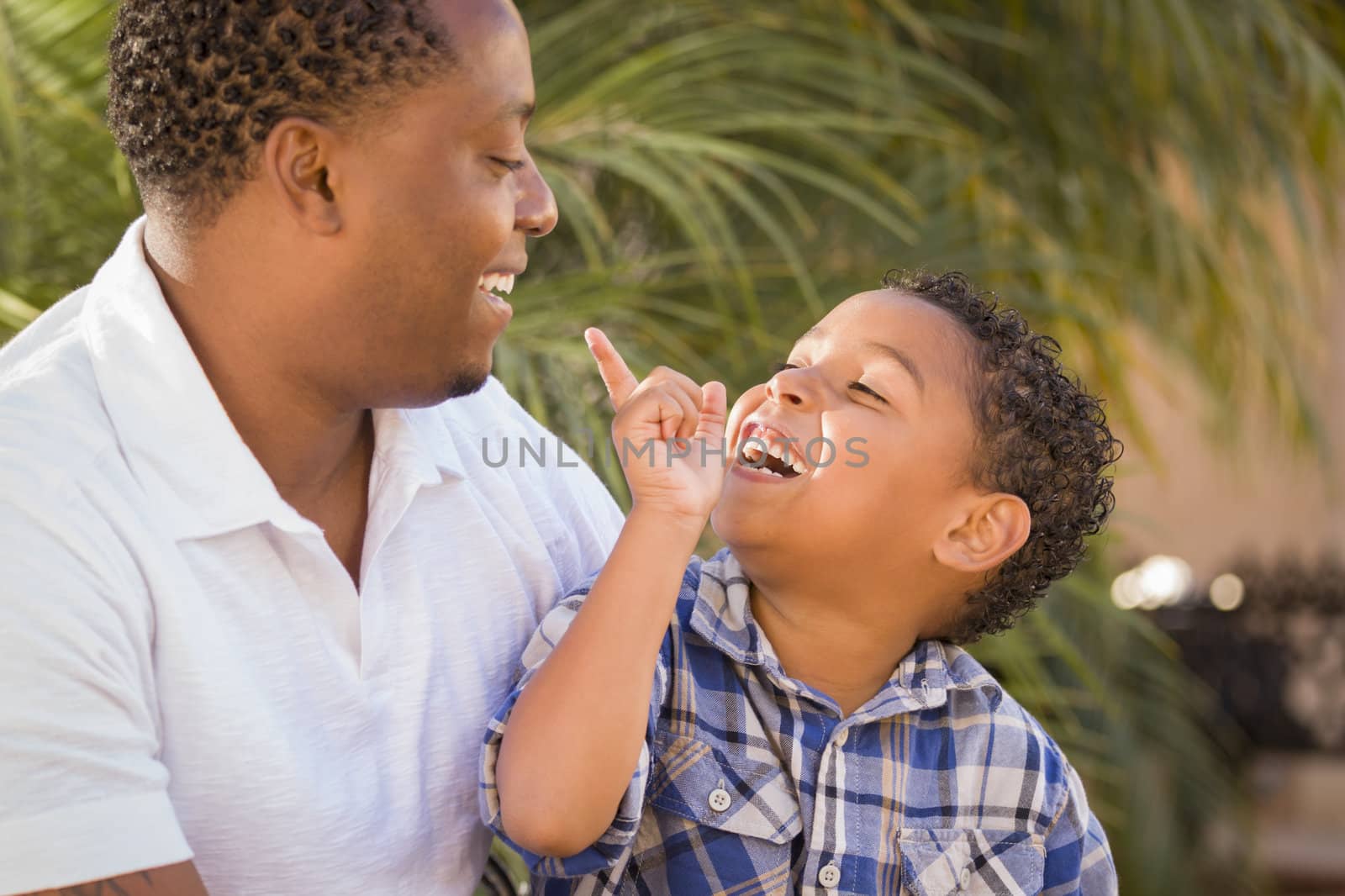 Happy Mixed Race Father and Son Playing by Feverpitched