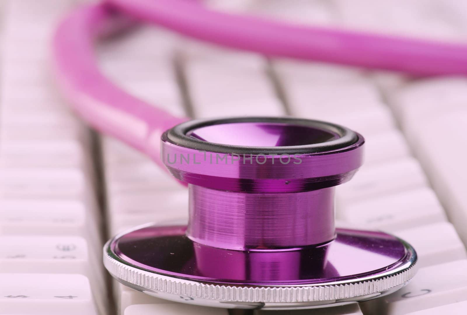 pink stethoscope on keyboard by clearviewstock