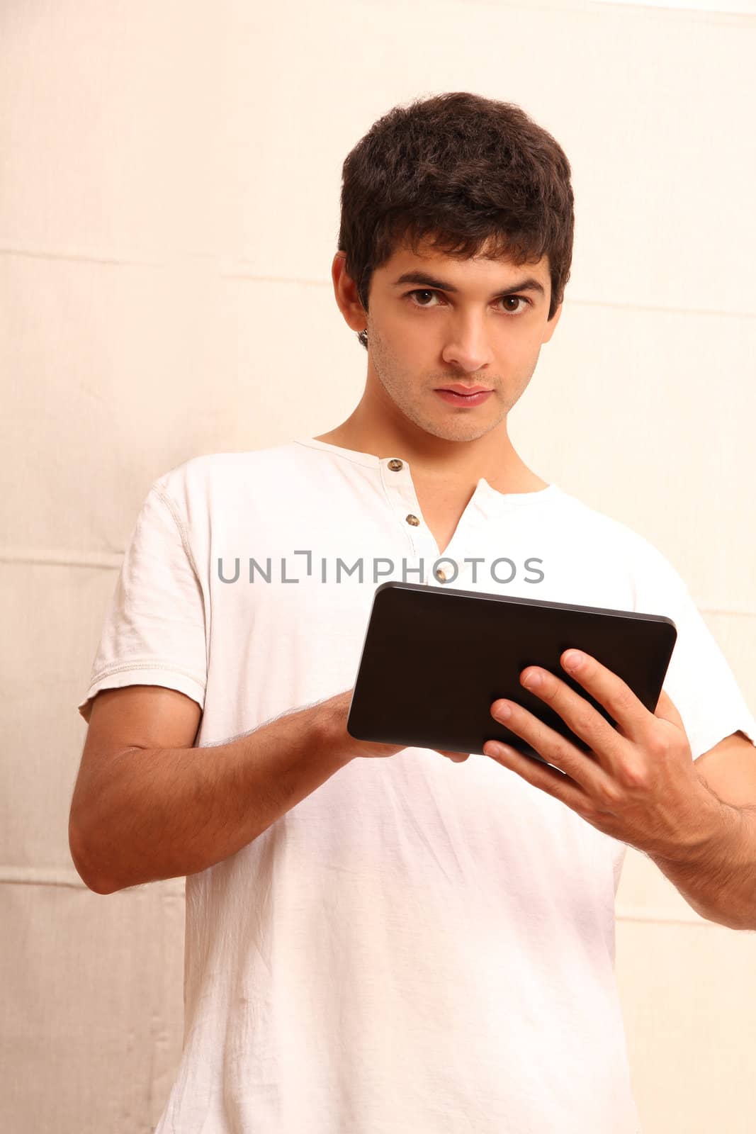 A young hispanic man using a Tablet PC.