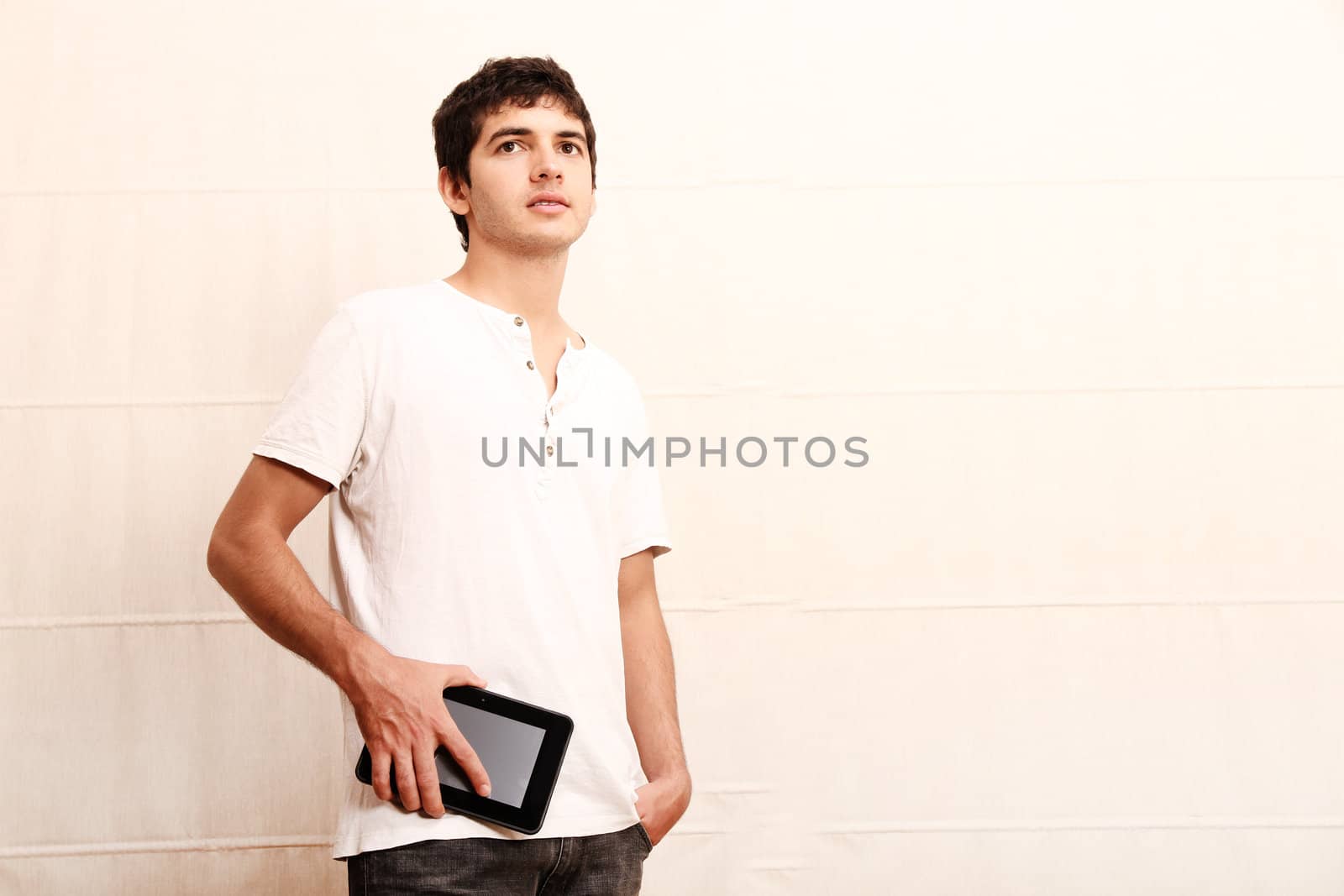 A young hispanic man using a Tablet PC.