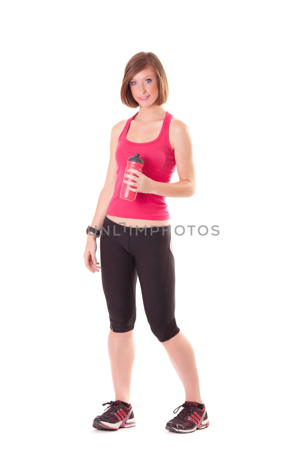 young beautiful sport woman standing with a bottle isolated on w by Lcrespi