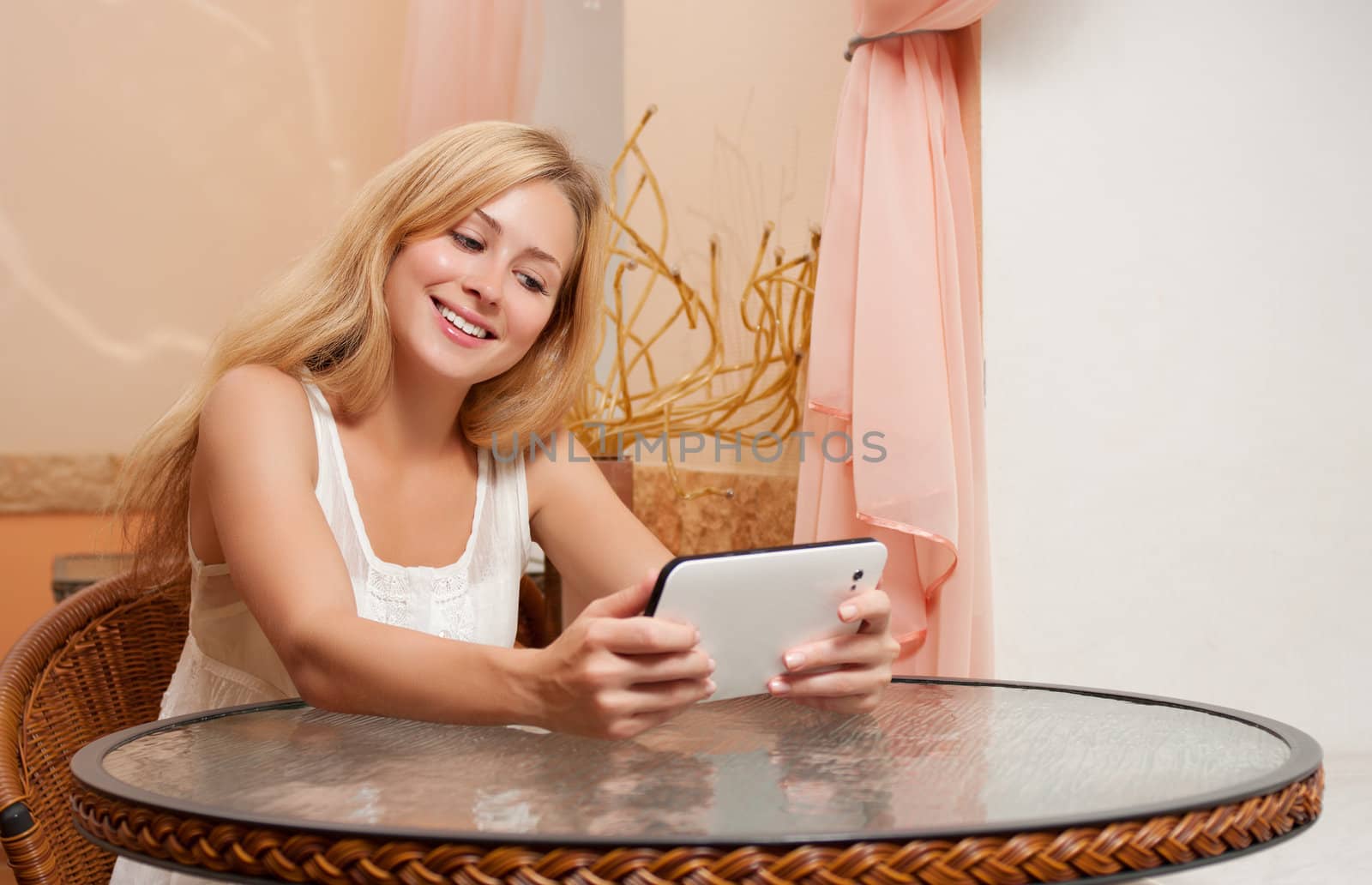 Young woman in cafe with tablet computer