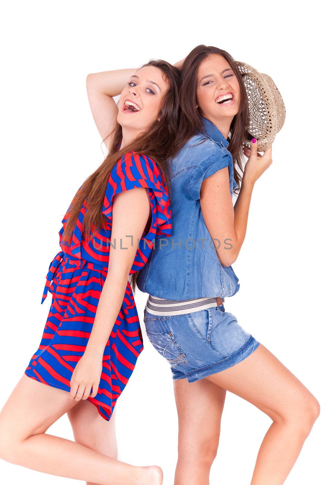 portrait of two young beautiful friends playing and having fun on white background