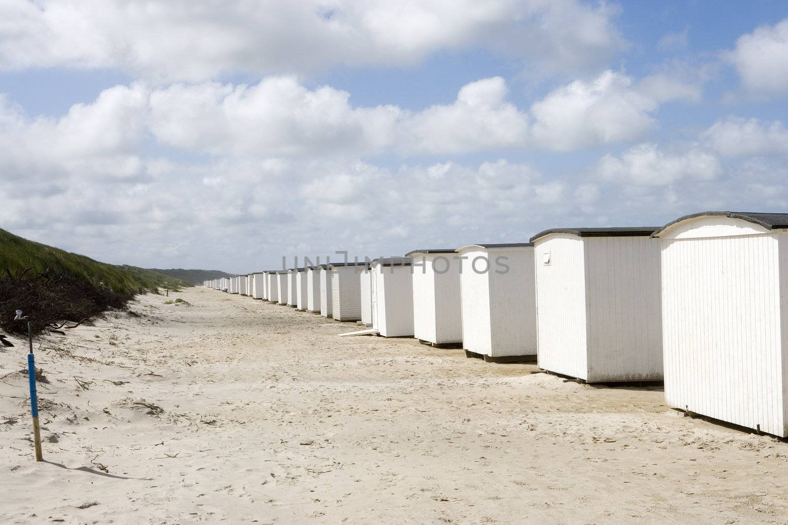 Row of White boathouses on the beach