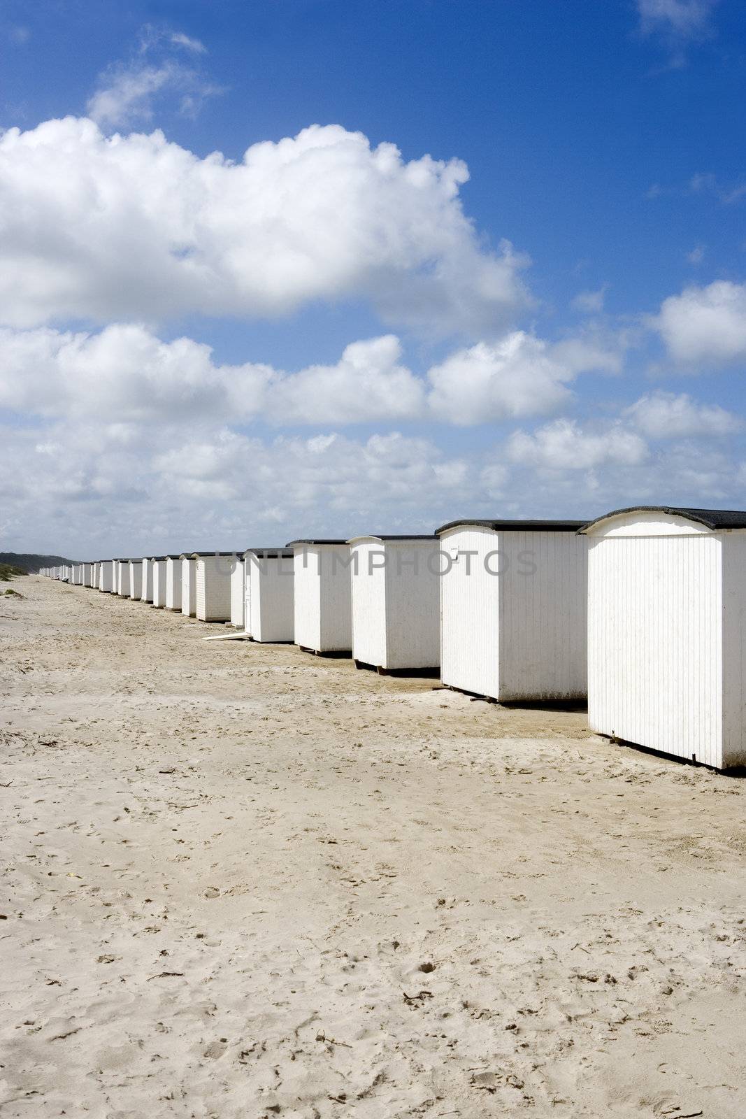 Row of White boathouses on the beach