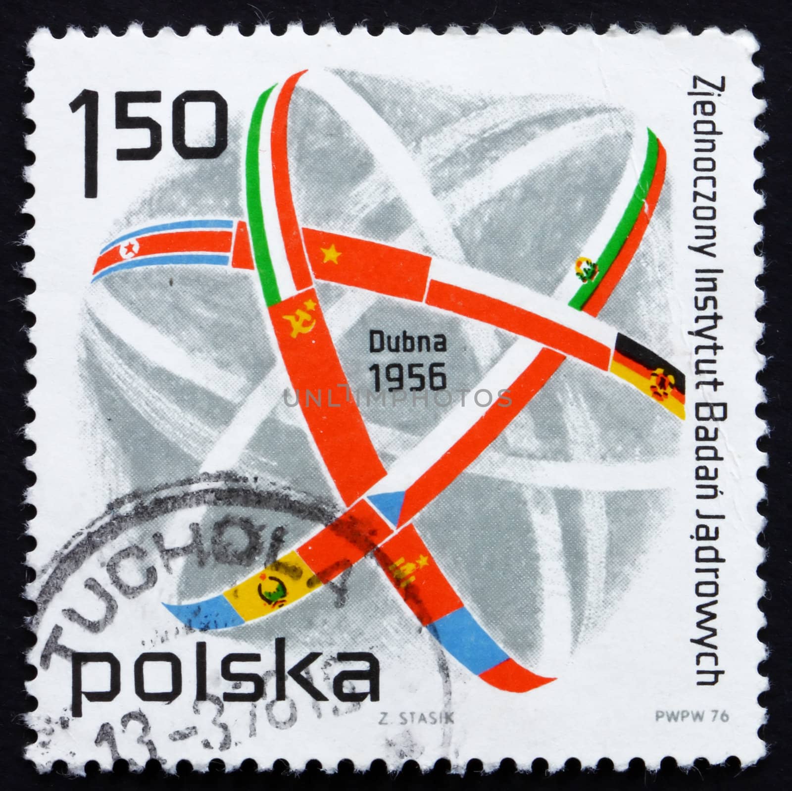 POLAND - CIRCA 1976: a stamp printed in the Poland shows Atom Symbol and Flags, 20th Anniversary of Joint Institute of Nuclear Research, Dubna, circa 1976