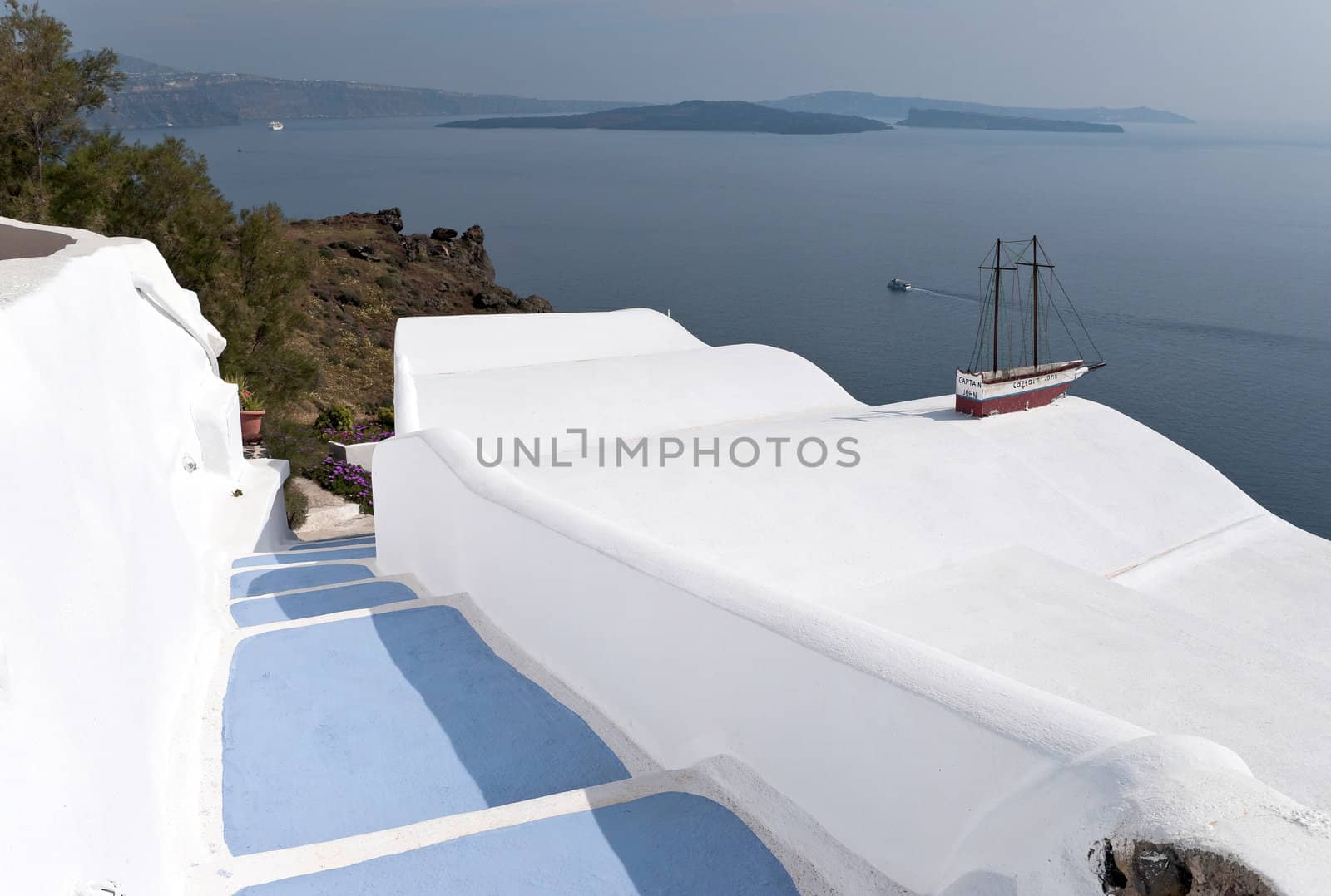 Caldera view in Santorini island with blue steps to the buildings on the cliff