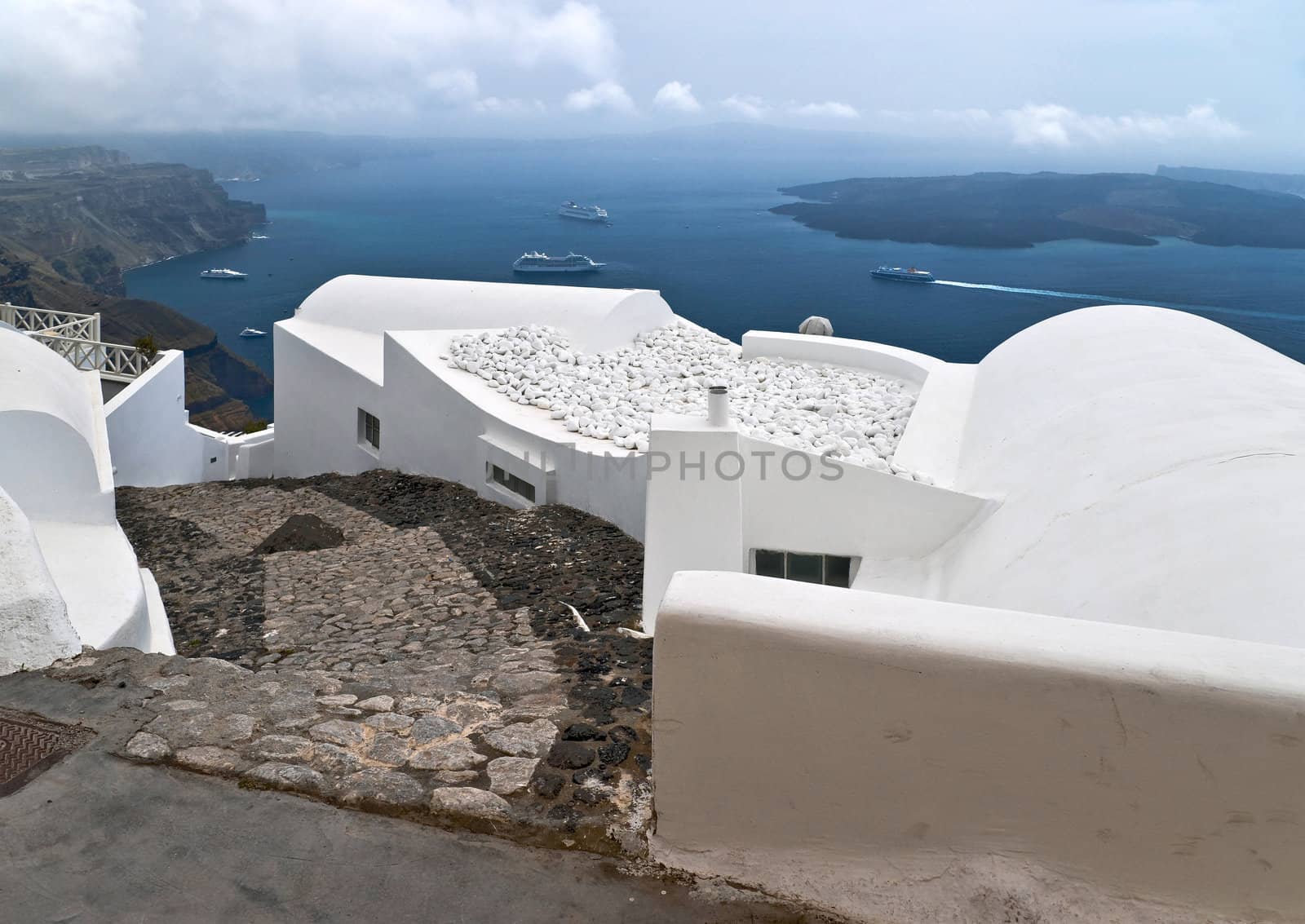 Caldera view in Santorini island with white buildings and ships
