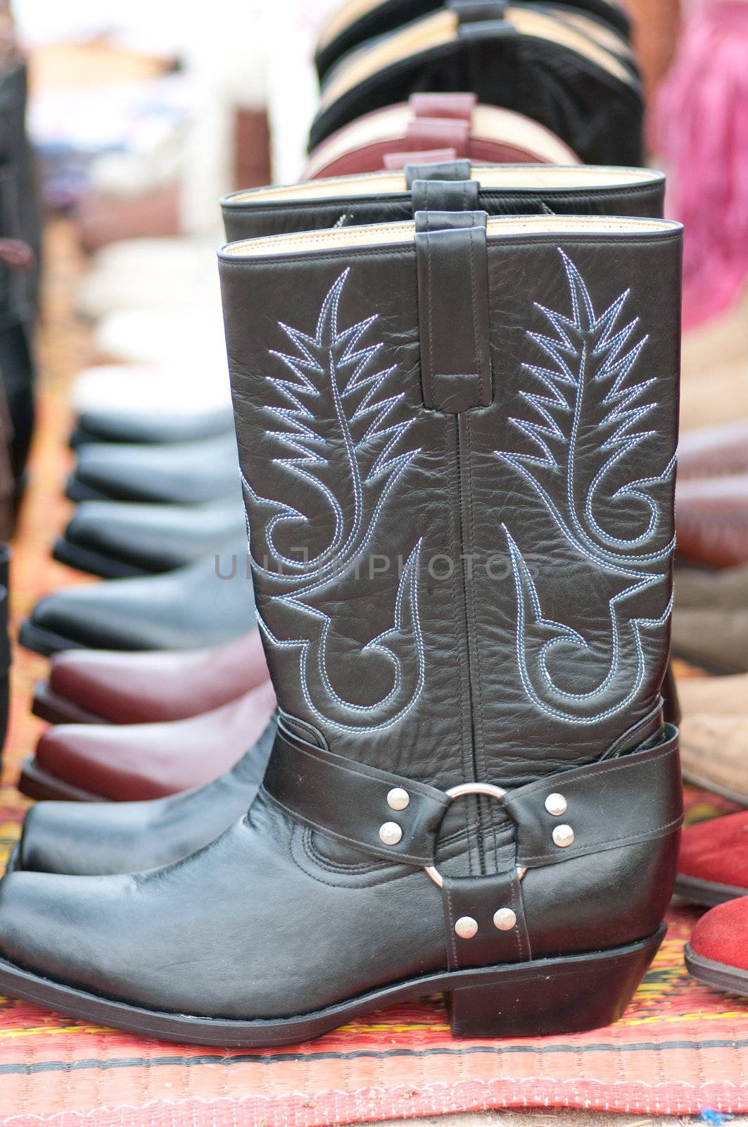 a line of black cowboy boots