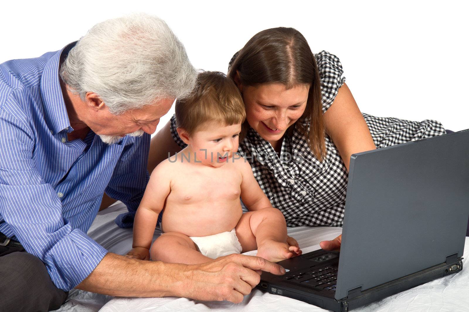 mother and grandfather with baby play with pc