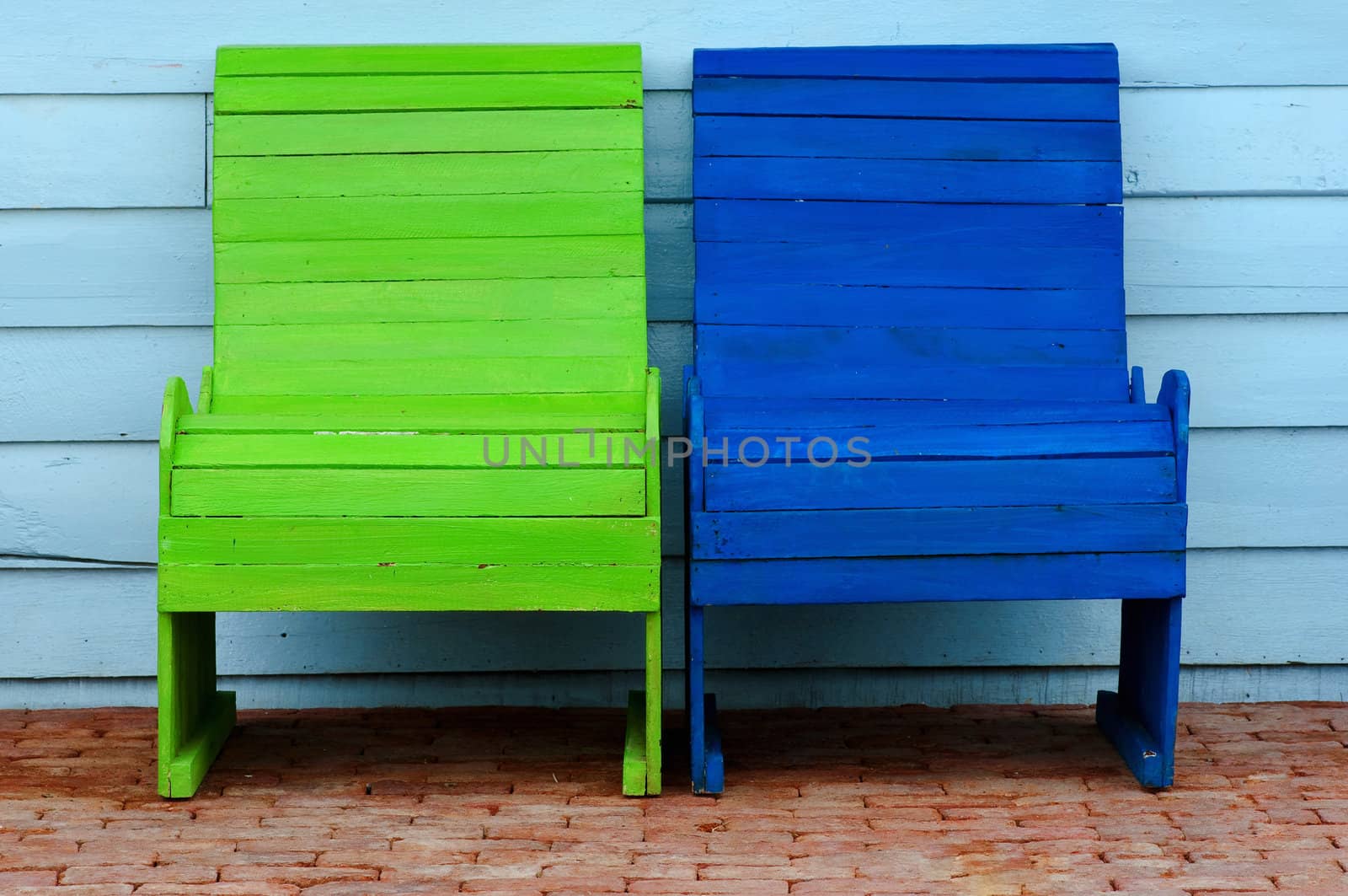 light green and blue chairs on ancient red brick