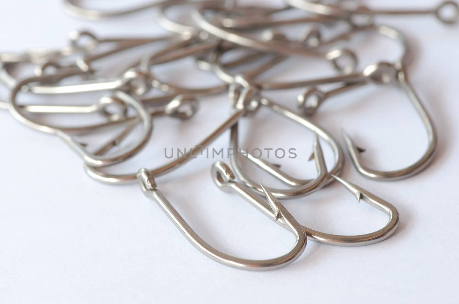 Stainless steel fishing hook on white 