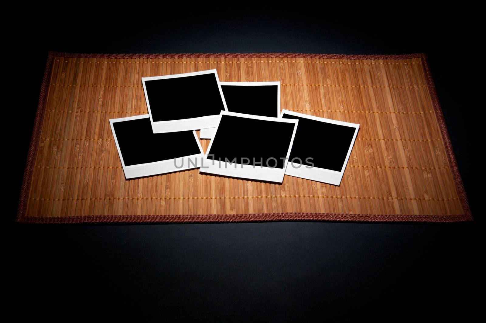 Blank photo frames on bamboo napkin