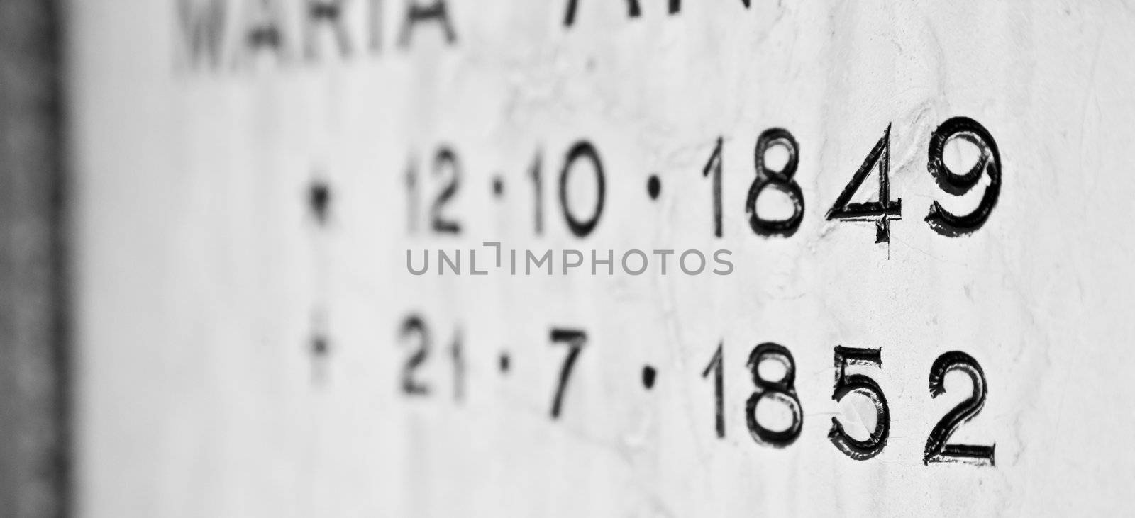 Old tombstone in Italian cemetery with birth and death dates