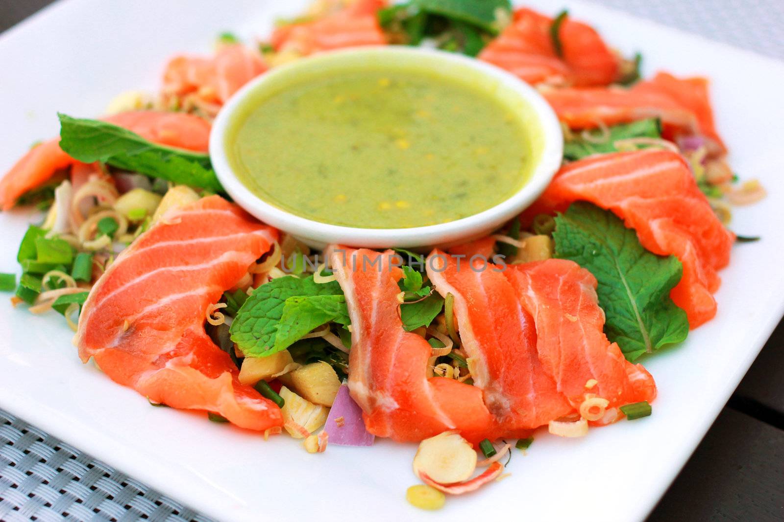 Spicy salmon salad with wasabi sauce 