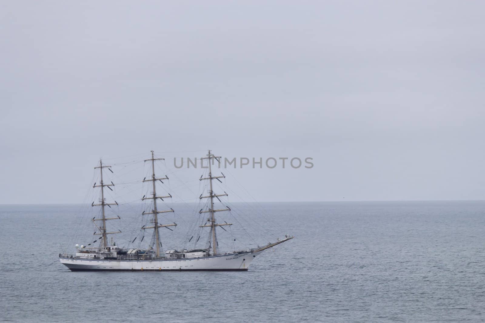 Sailing vessel "Nadezhda" in the sea in the cloudy afternoon
