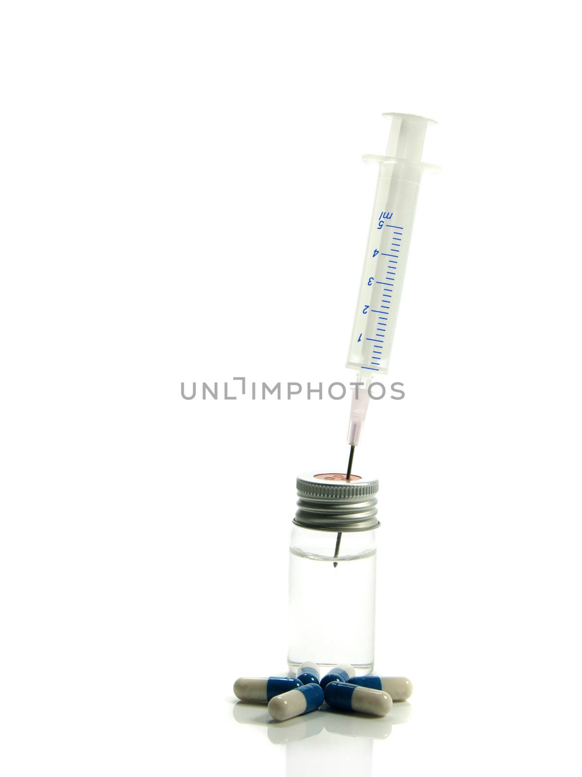 medical needle in bottle with liquid and medicine by compuinfoto
